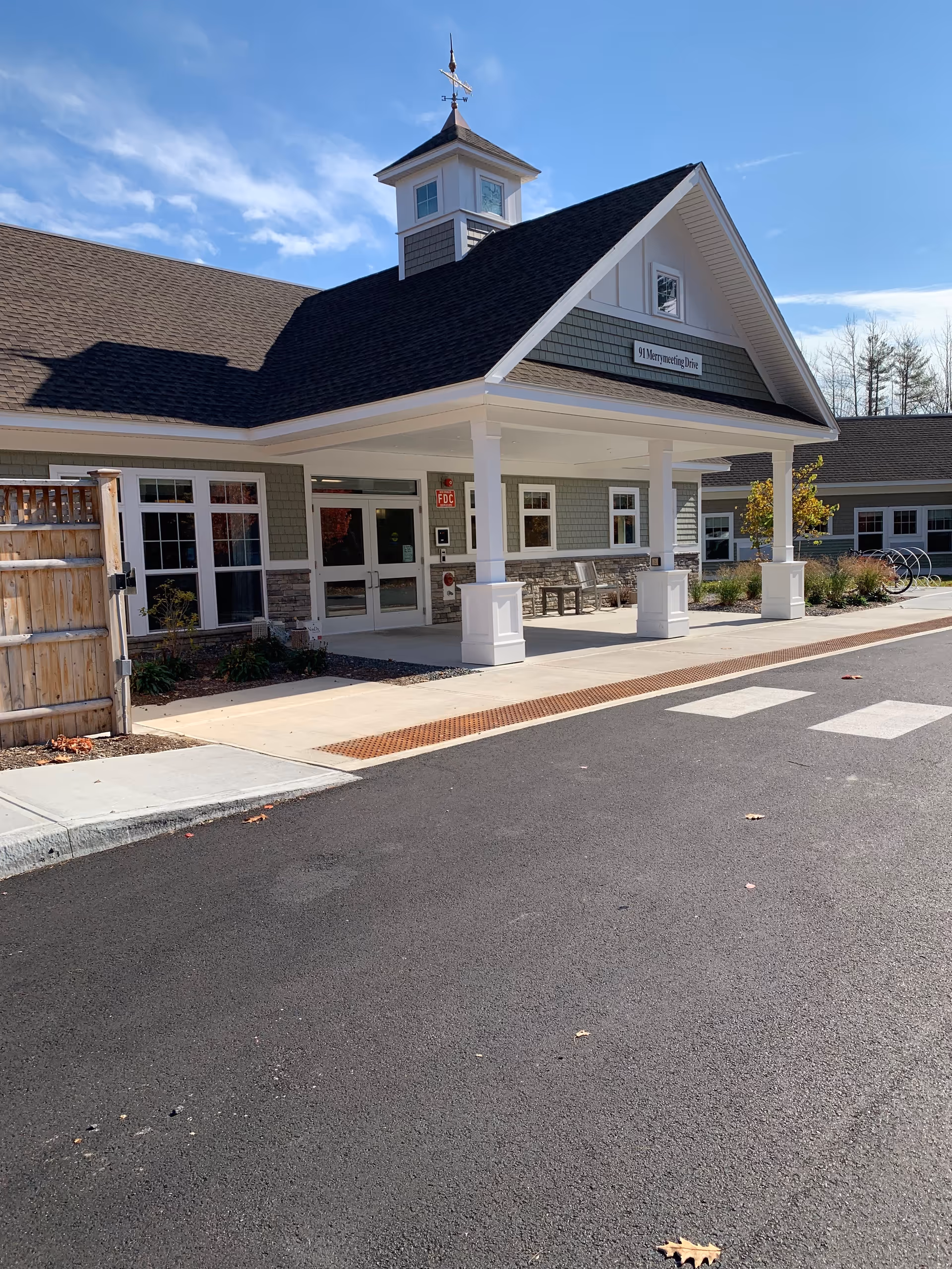 Front entrance of Fallbrook Woods senior living facility with a sheltered canopy.