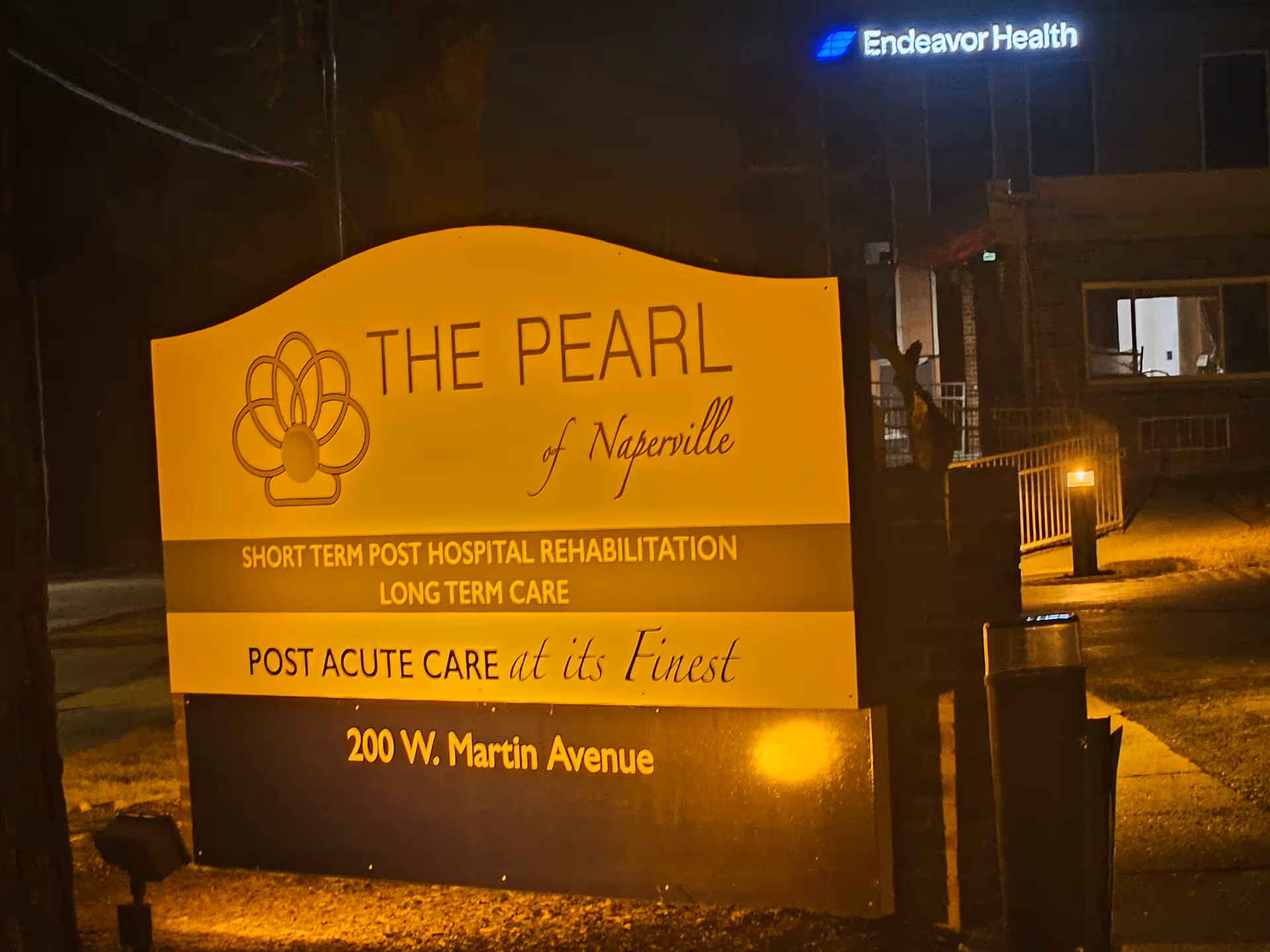 Illuminated sign for The Pearl of Naperville outside the building at 200 W. Martin Avenue