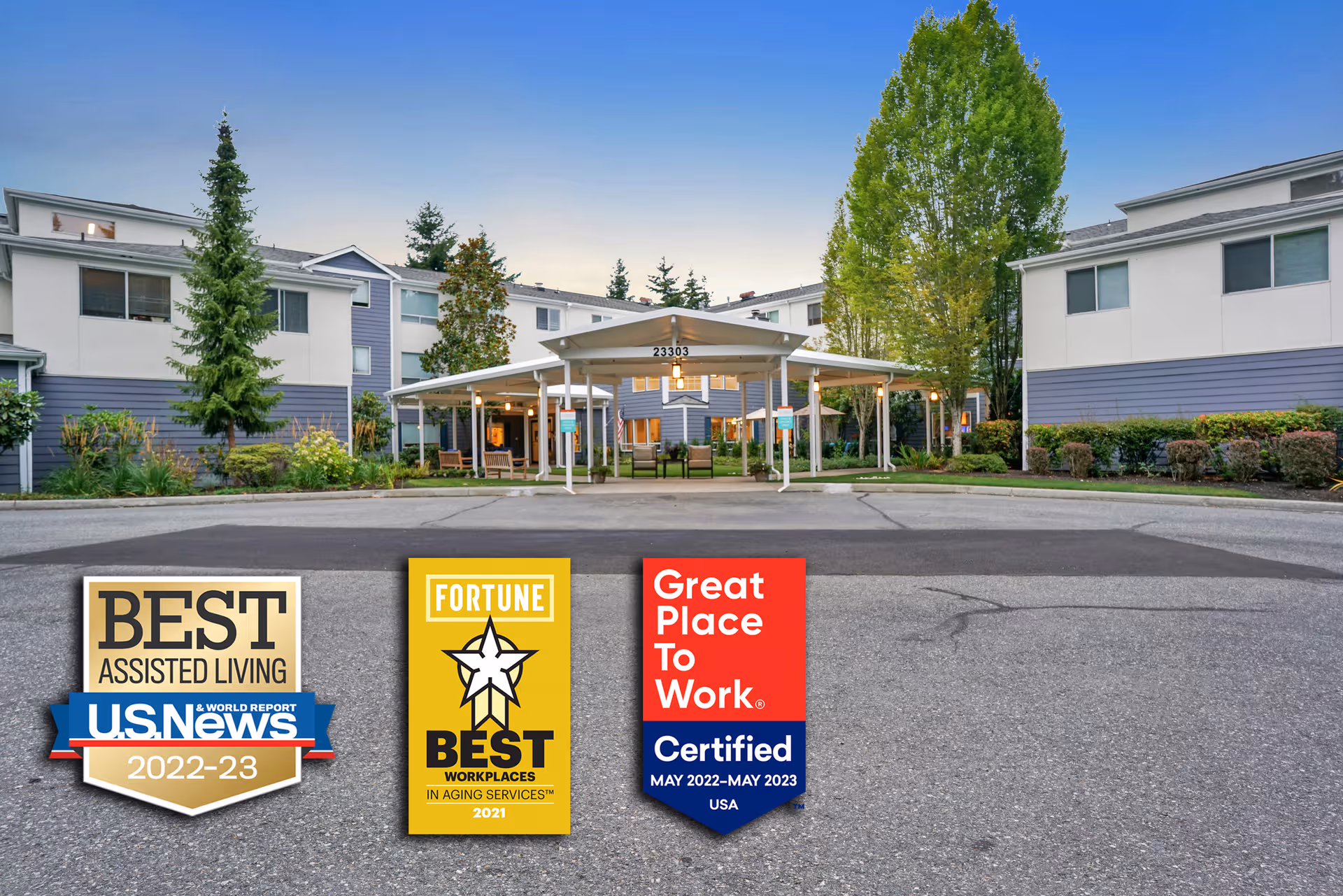 Exterior view of Mountlake Terrace Plaza with a covered entrance and award signs in foreground.