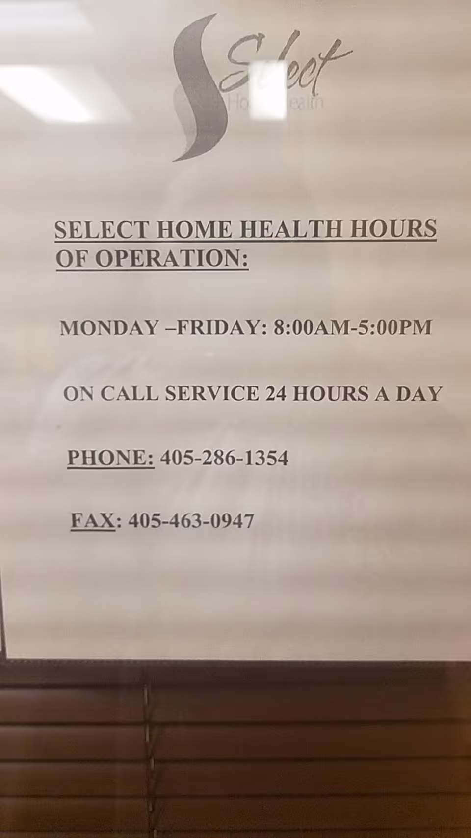 Indoor sign for Select Home Health displaying hours of operation and contact information.