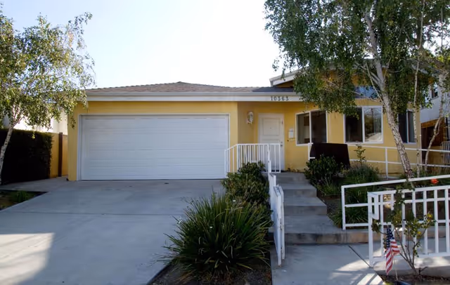 Front exterior of Ayres Residential Care Homes, Century City, with garage, steps, and landscaping.