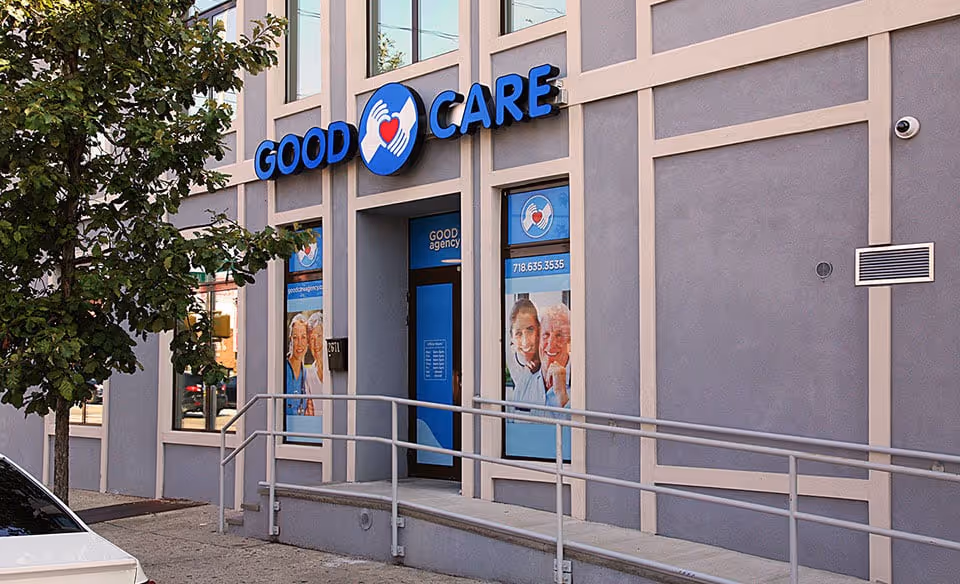 Front view of a Good Care storefront with blue signage and a wheelchair ramp.