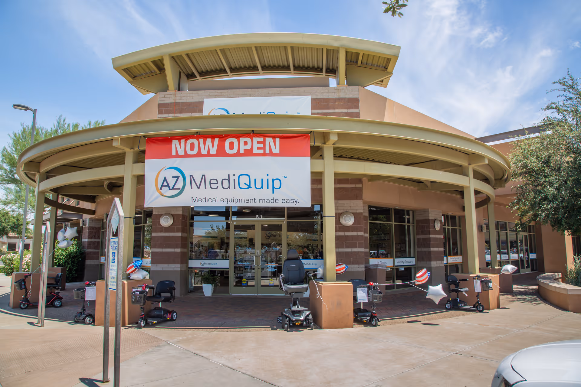 AZ MediQuip storefront with a red Now Open banner and curved entrance.
