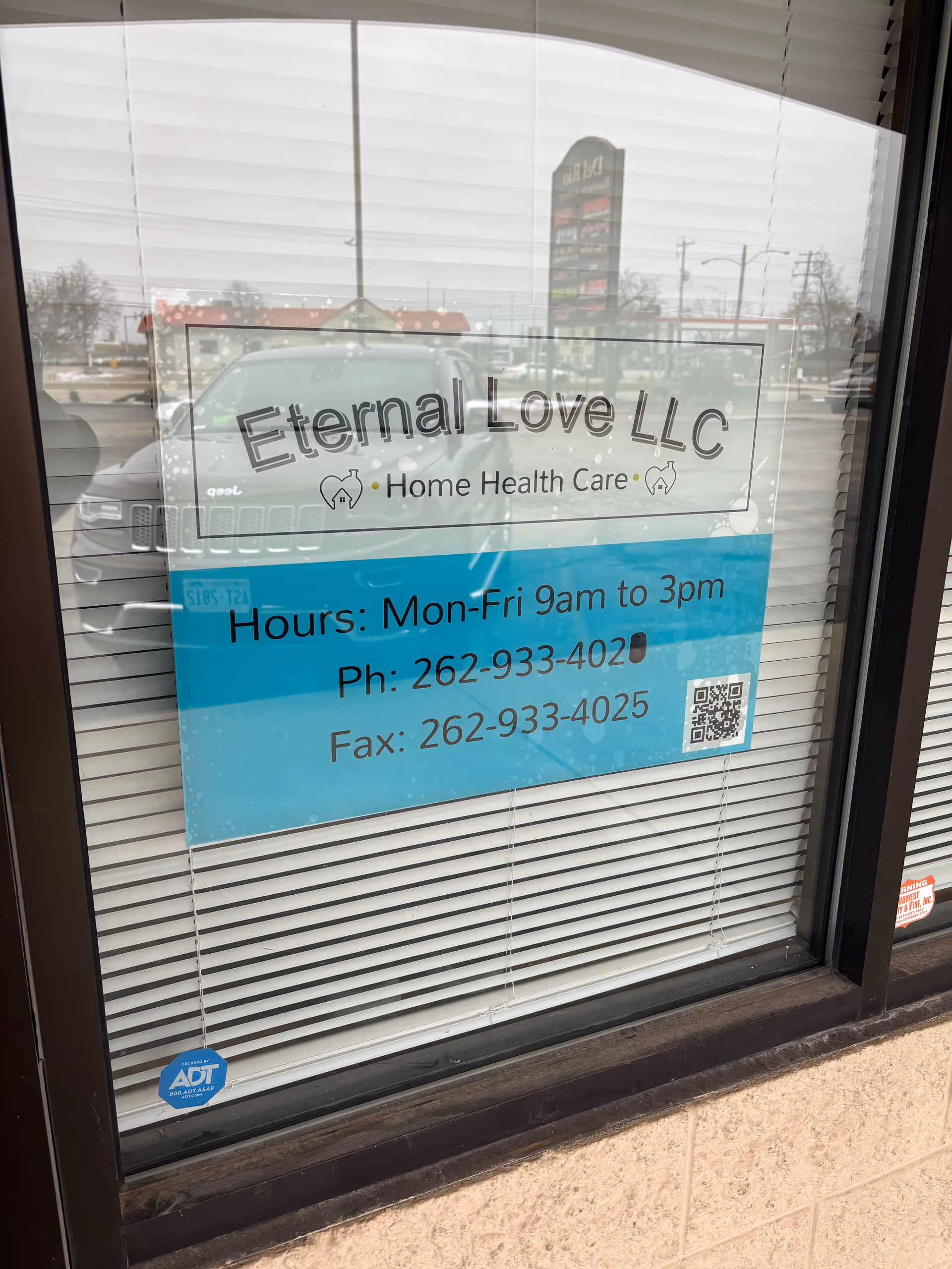 Storefront window signage for Eternal Love, LLC Home Health Care with hours.