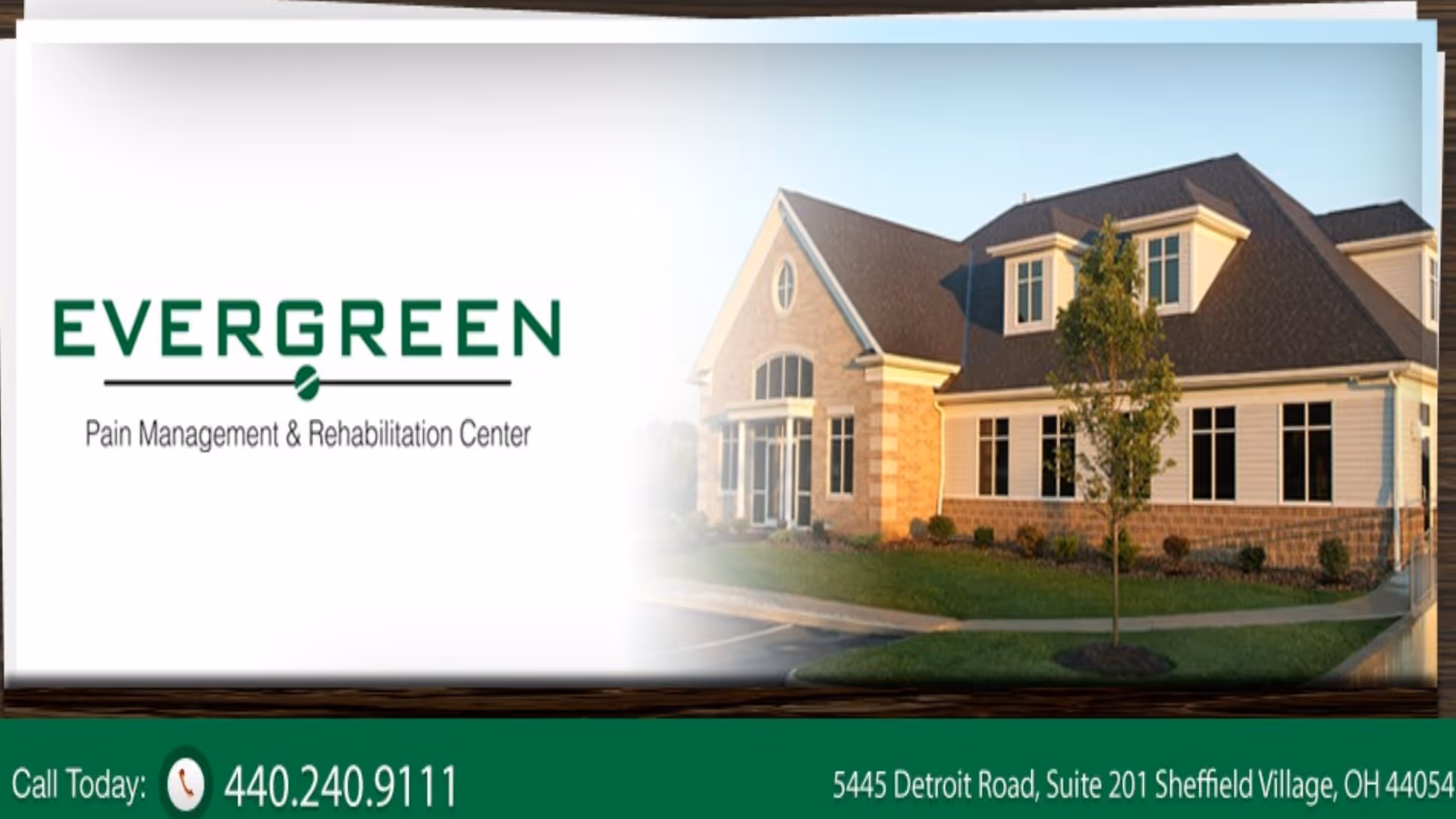 Exterior view of Evergreen Pain Management & Rehabilitation Center with logo and lawn.