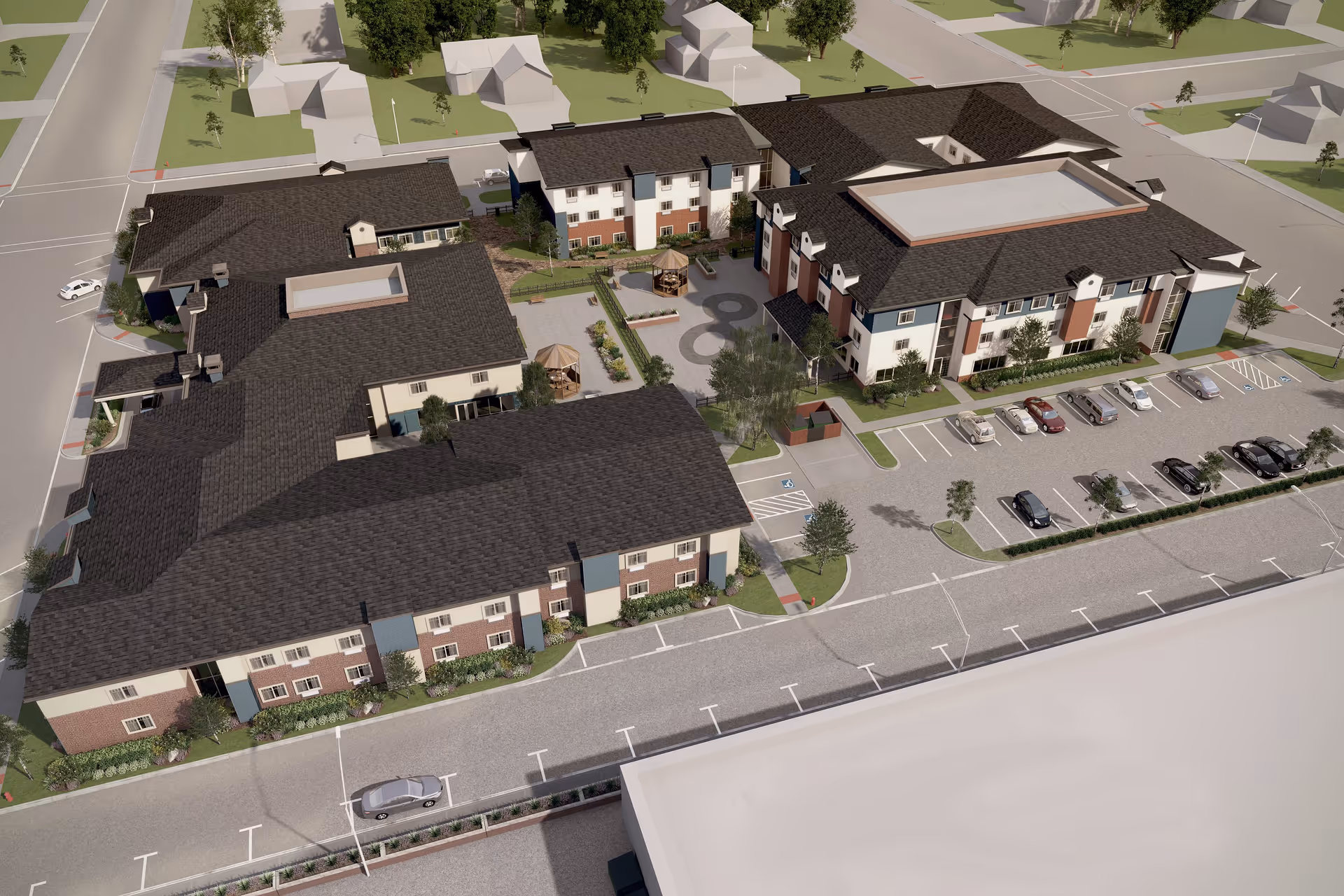Aerial view of Summerset Senior Living, Lincoln showing a large multi-building complex with landscaped courtyards, parking lots with cars, and surrounding streets with houses and trees.