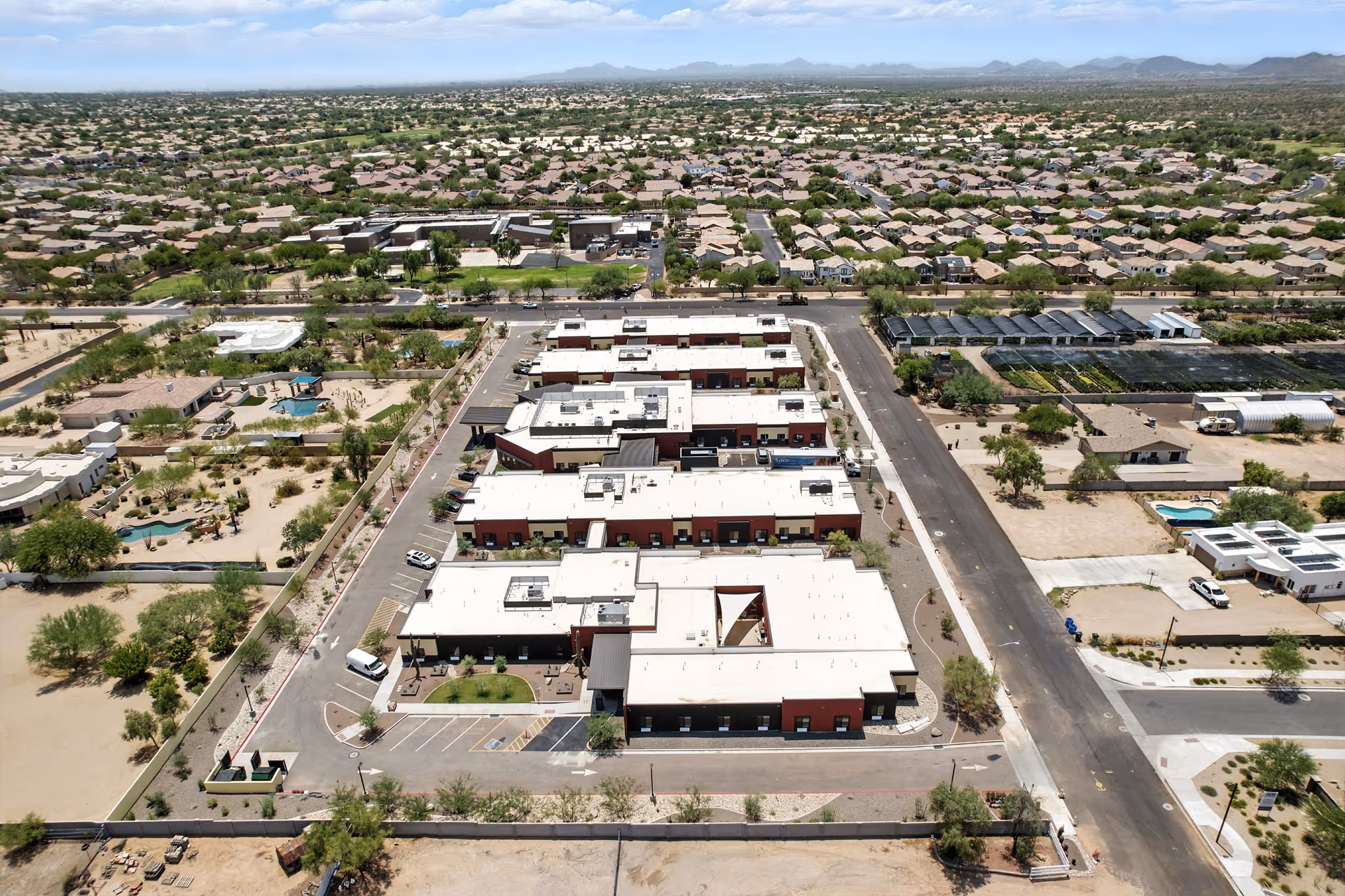 Aerial view of Cave Creek Assisted Living campus with low connected buildings in a desert town