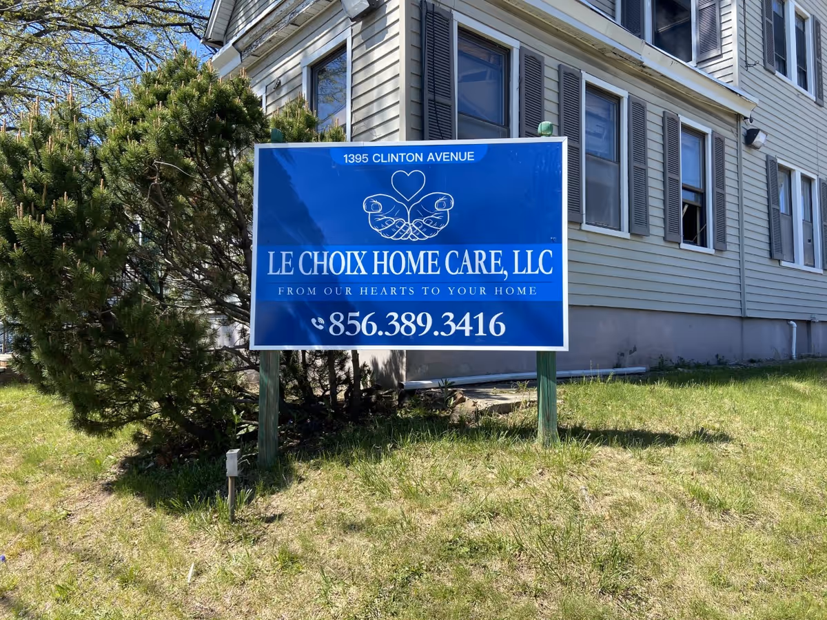Blue Le Choix Home Care LLC sign in front of a beige, multi-windowed building.