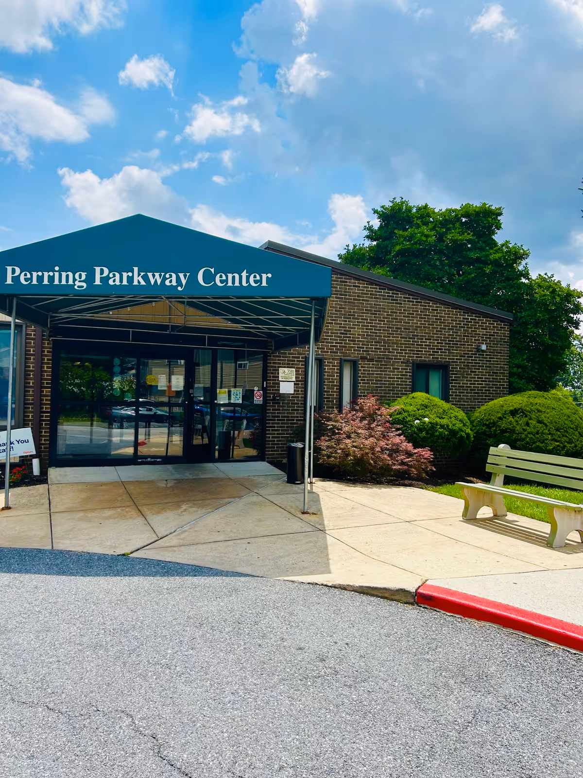 Front view of Autumn Lake Healthcare at Perring Parkway entrance under a teal canopy.