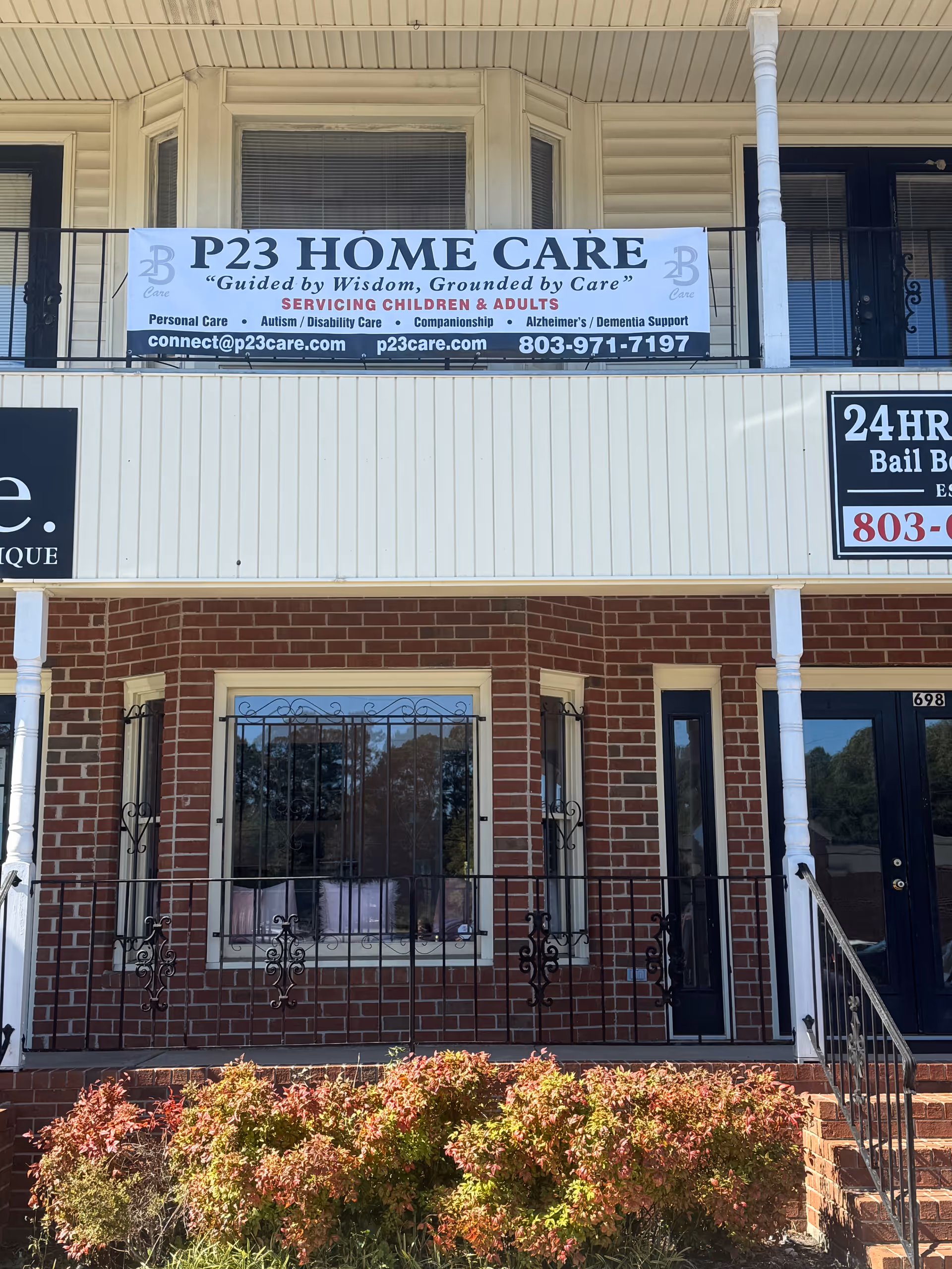 Facade of a two-story building with a P23 Home Care banner on the front.