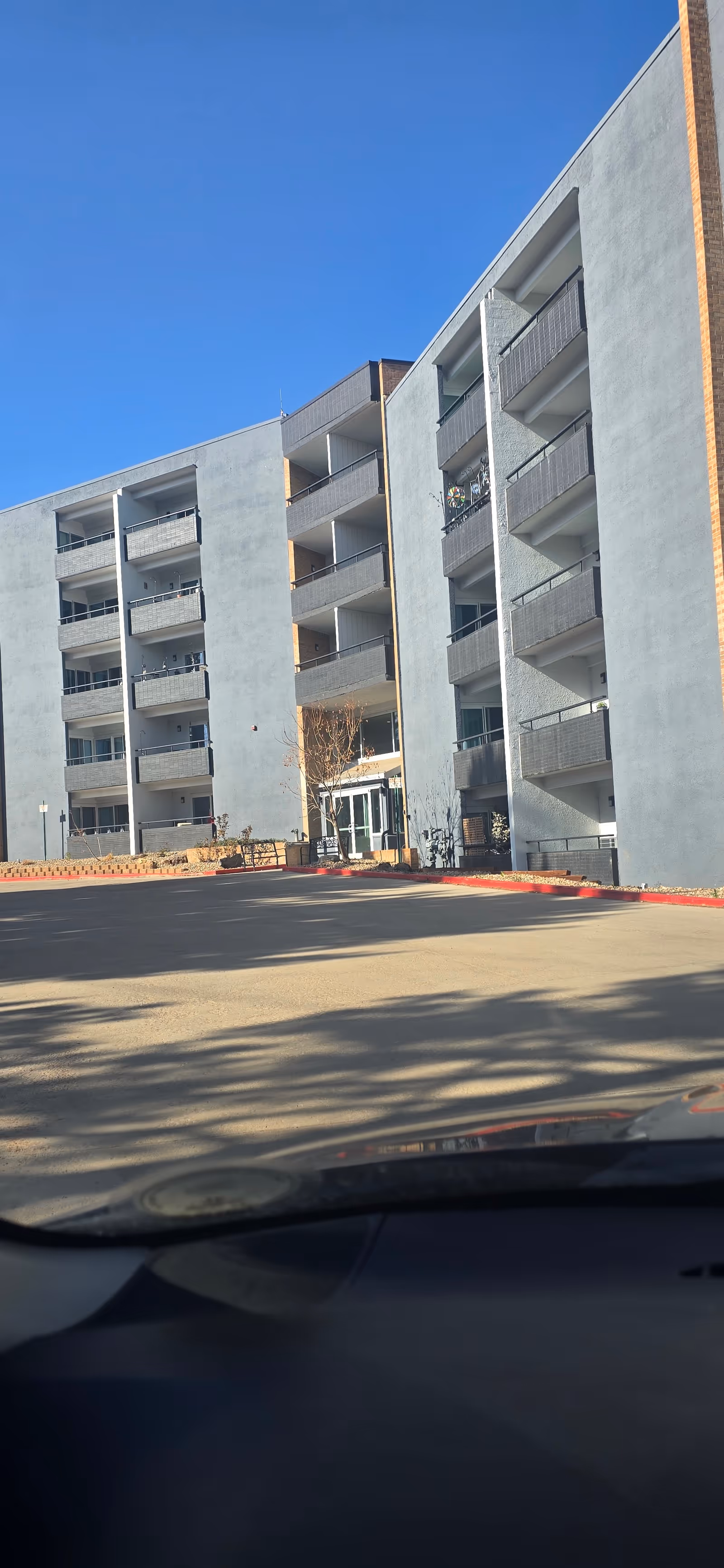 Exterior view of The Windemere senior living building with balconies and entrance.