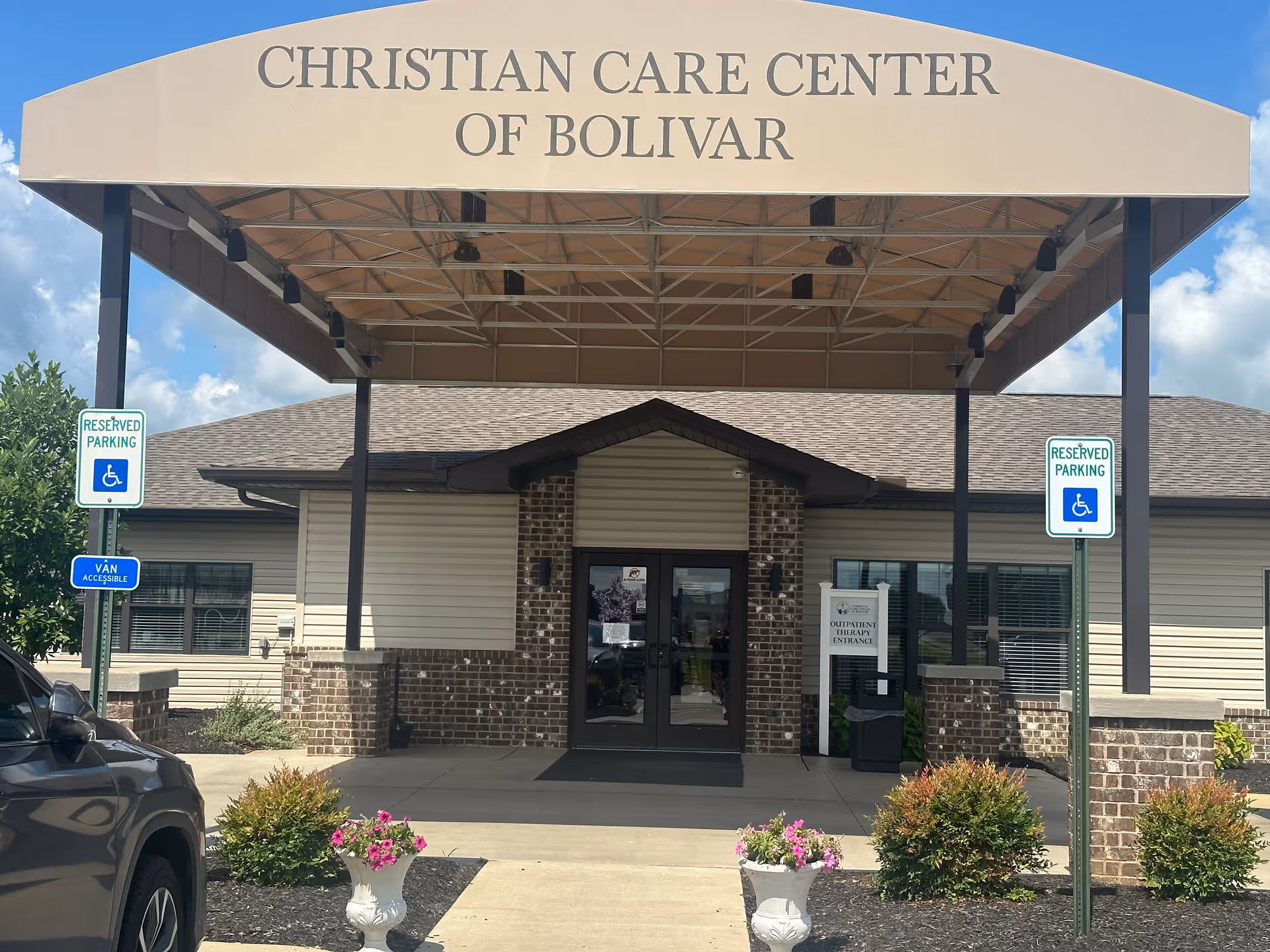 Entrance to Christian Care Center of Bolivar with a large beige canopy.