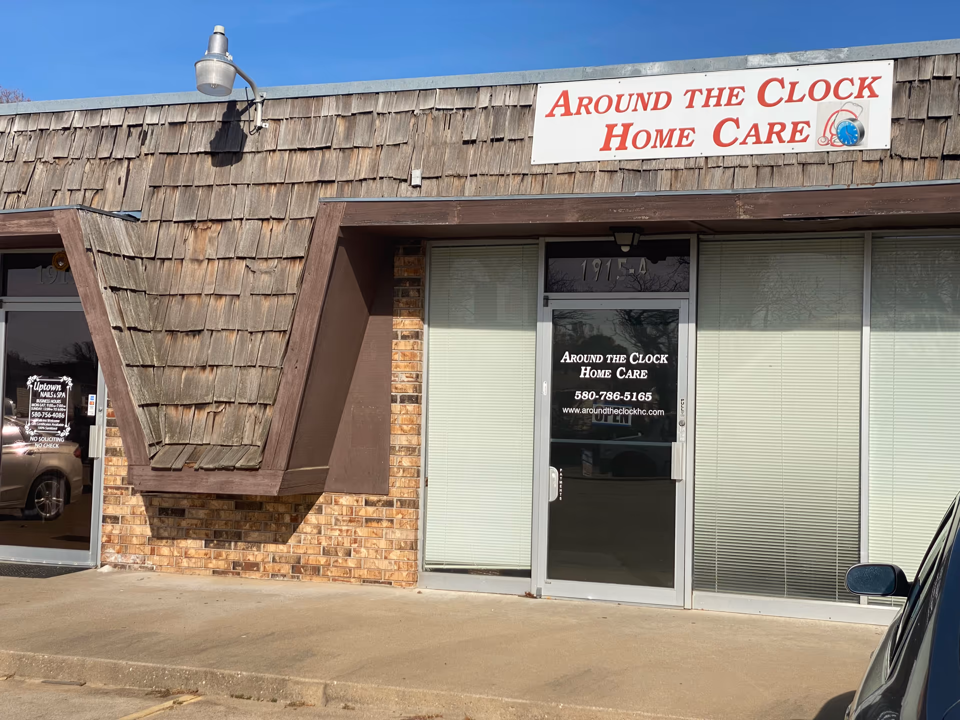 Exterior storefront with sign Around the Clock Home Care above the glass door.
