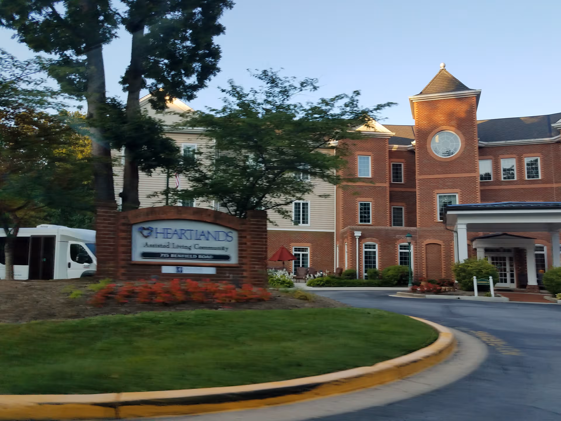 Exterior view of HeartLands Assisted Living at Severna Park building and entrance with sign.