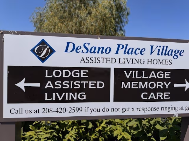 Outdoor sign for DeSano Place Village Assisted Living with arrows to Lodge and Memory Care.