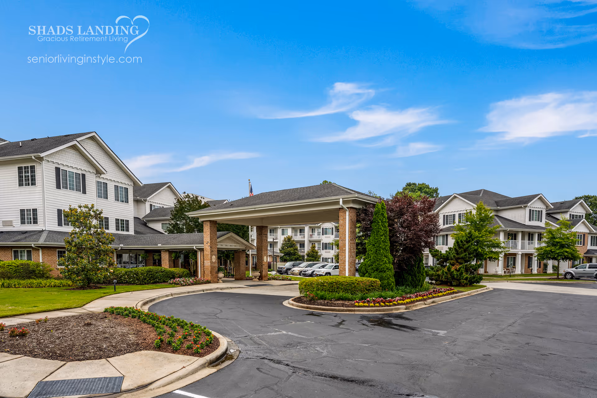 Exterior view of Shads Landing Gracious Retirement Living campus with entrance and landscaped roundabout