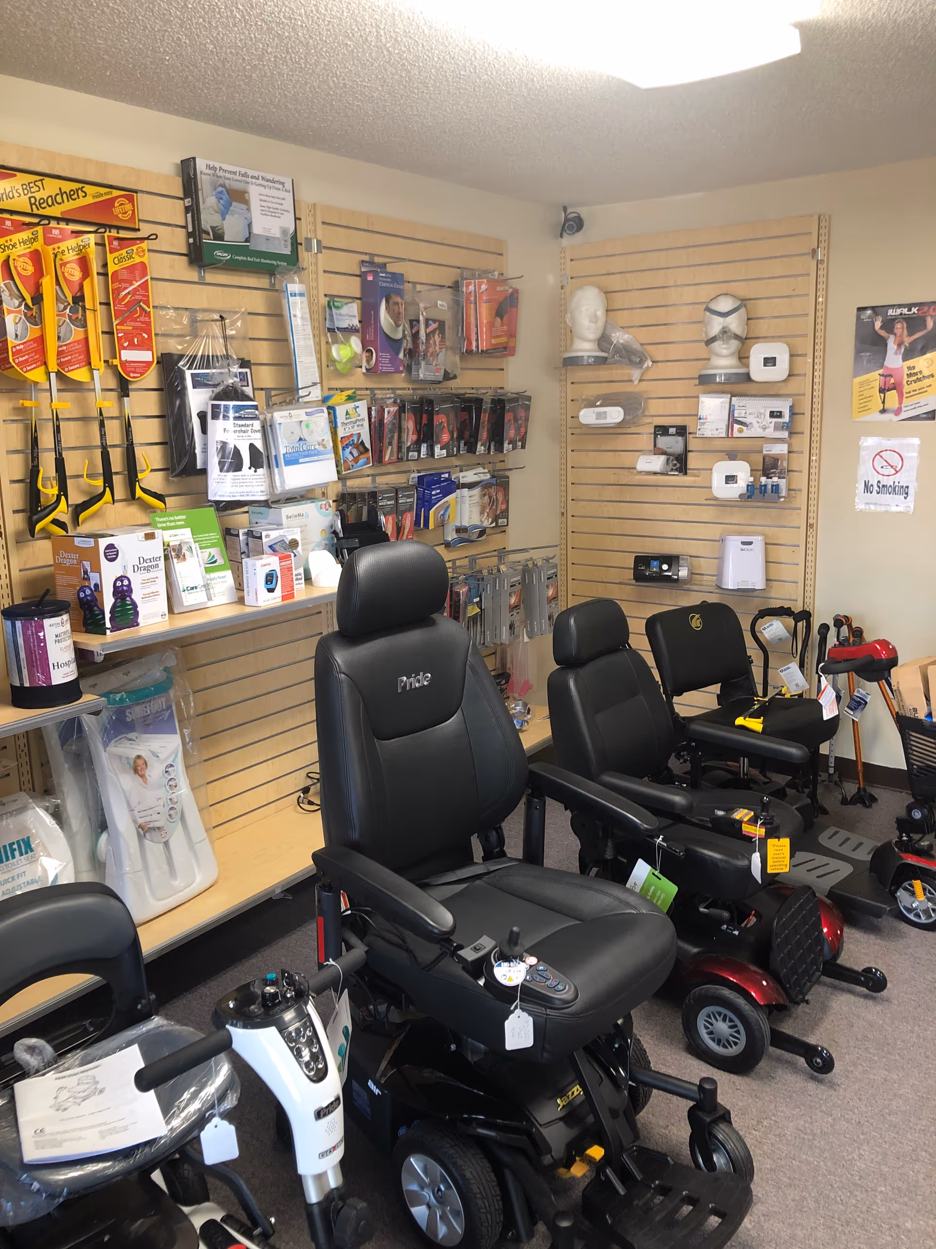Interior showroom displaying mobility scooters, assistive devices, and wall-mounted accessories.