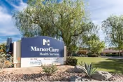 A landscaped outdoor view of the ManorCare Health Services Palm Desert entrance sign