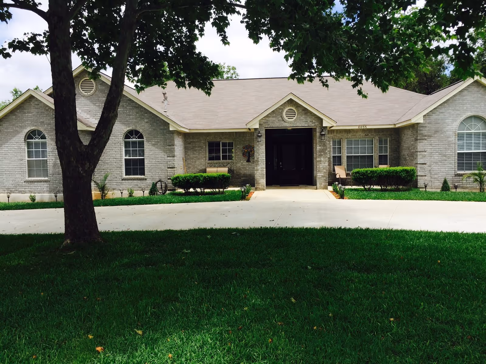 Front view of Pembroke Angel Care, showcasing a brick exterior with a landscaped yard and a welcoming entrance.