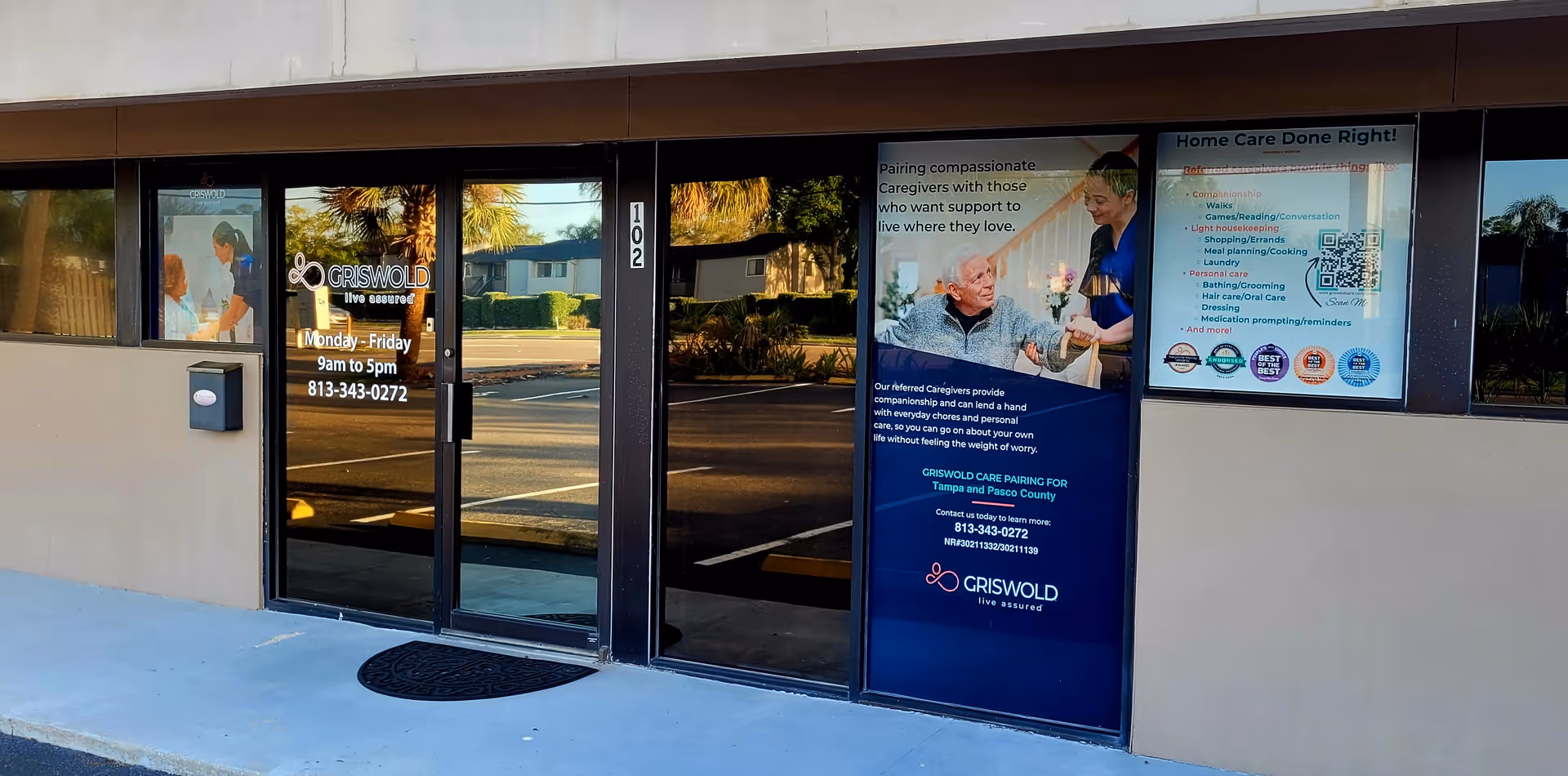 Exterior view of Griswold care facility entrance with glass doors and promotional posters.