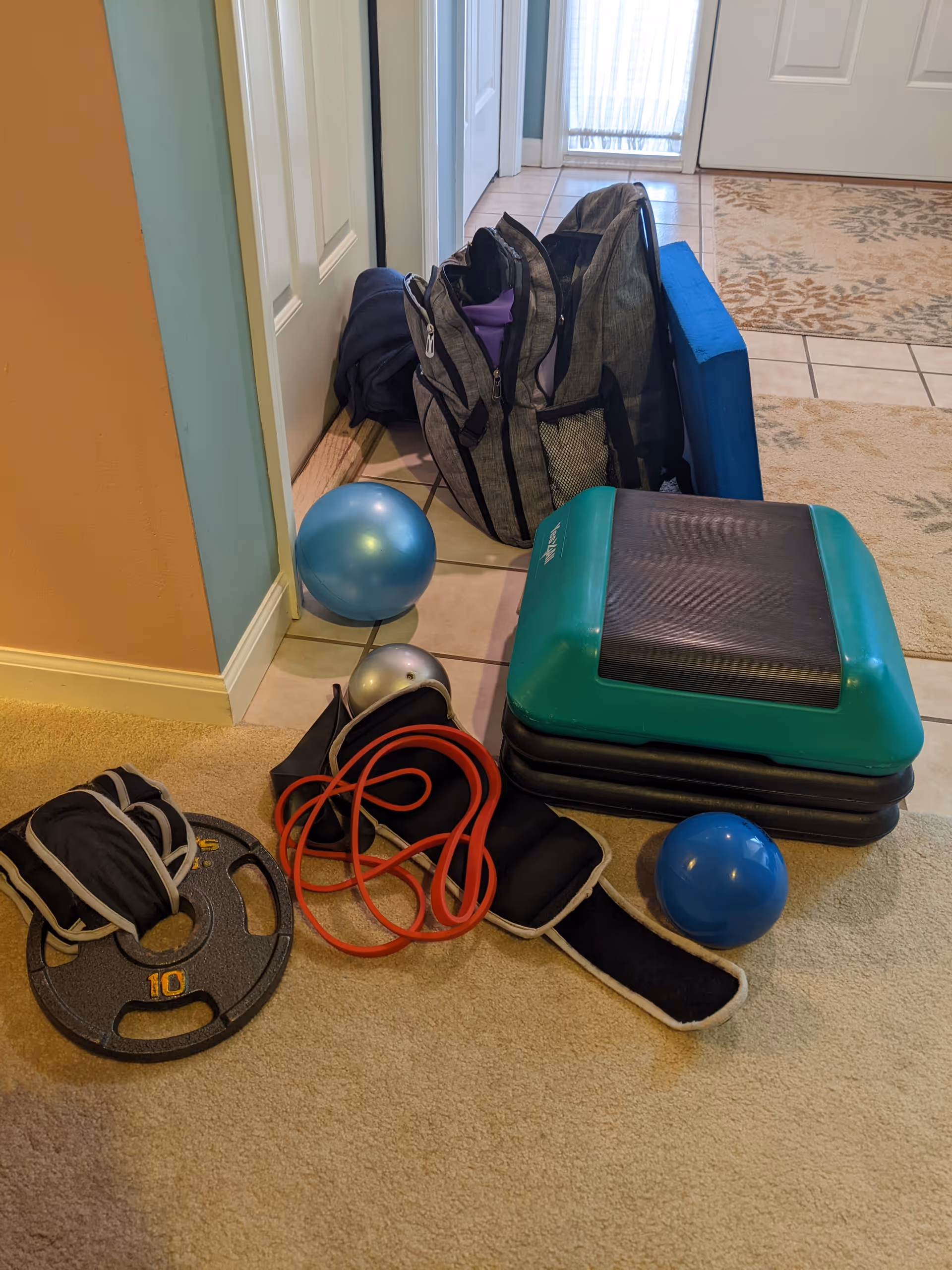 Fitness equipment and bags scattered near the entryway of a senior living facility.
