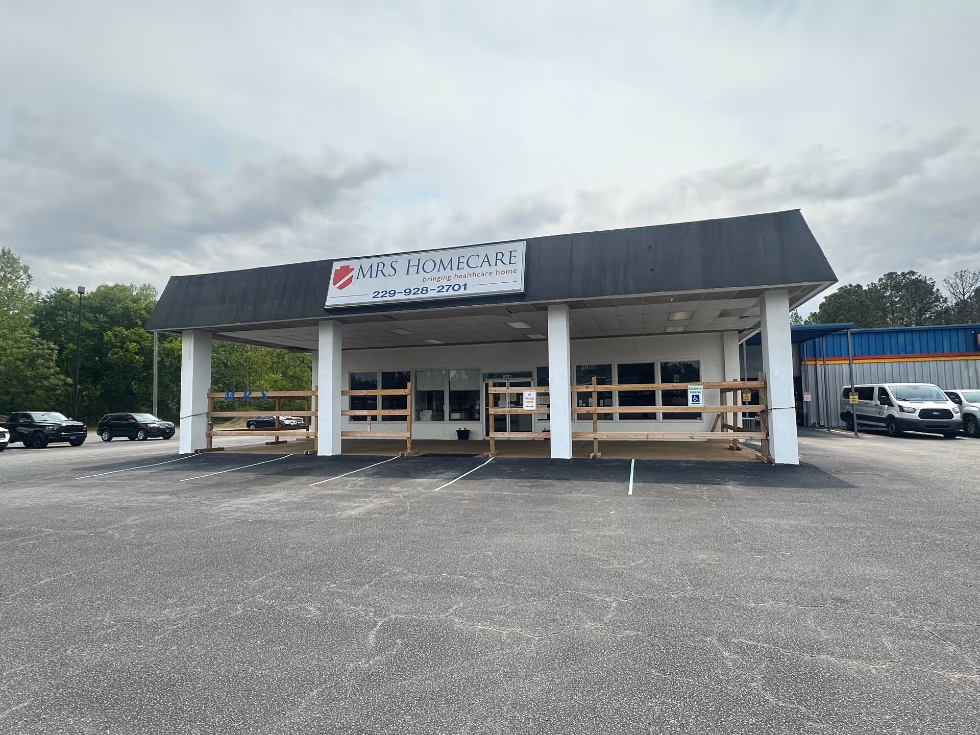 Front view of MRS Homecare facility with sign, porch, and parked cars.