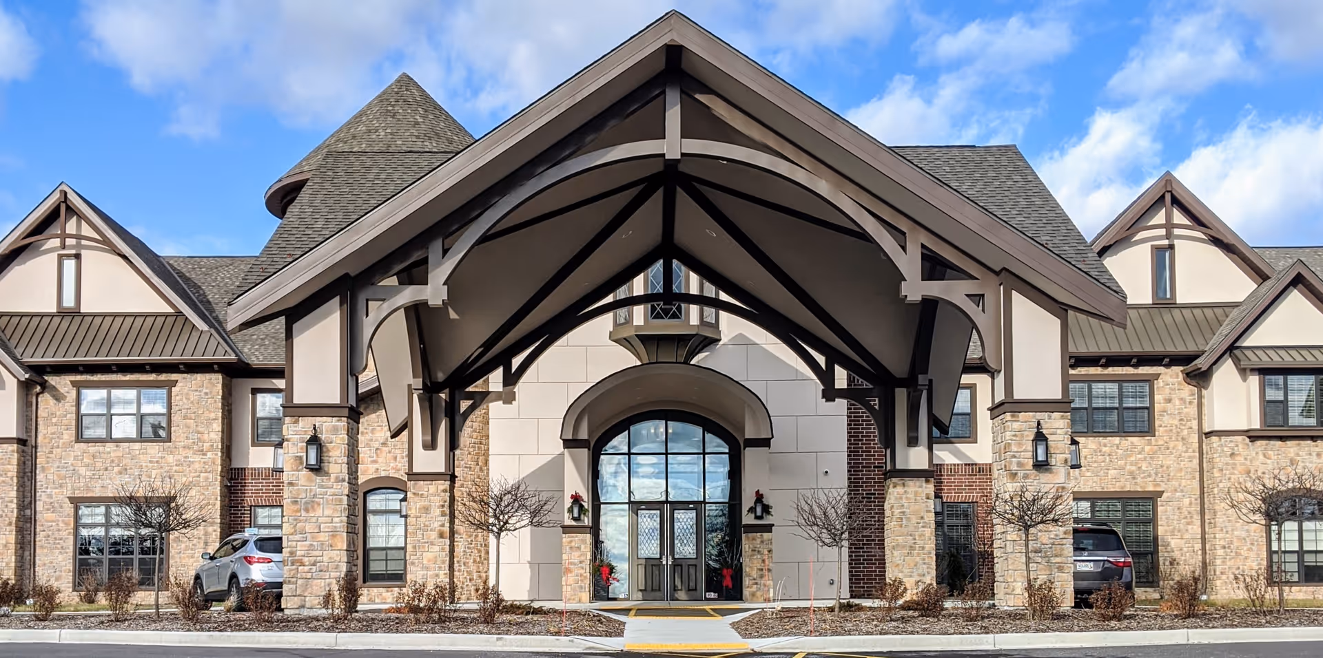 Front exterior of Discovery Commons Brookfield, a stone building with arched entry.
