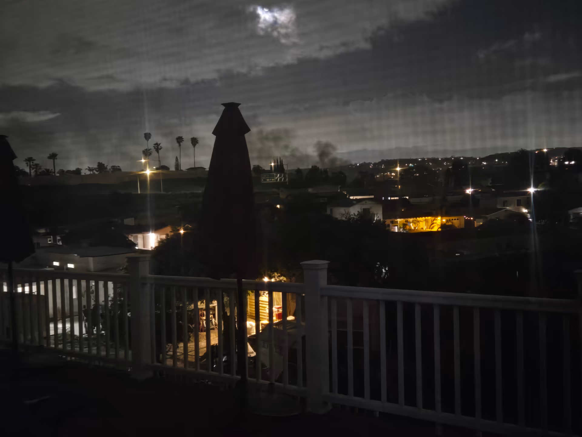 Night view from a balcony at Miracle Home and Care overlooking distant city lights.