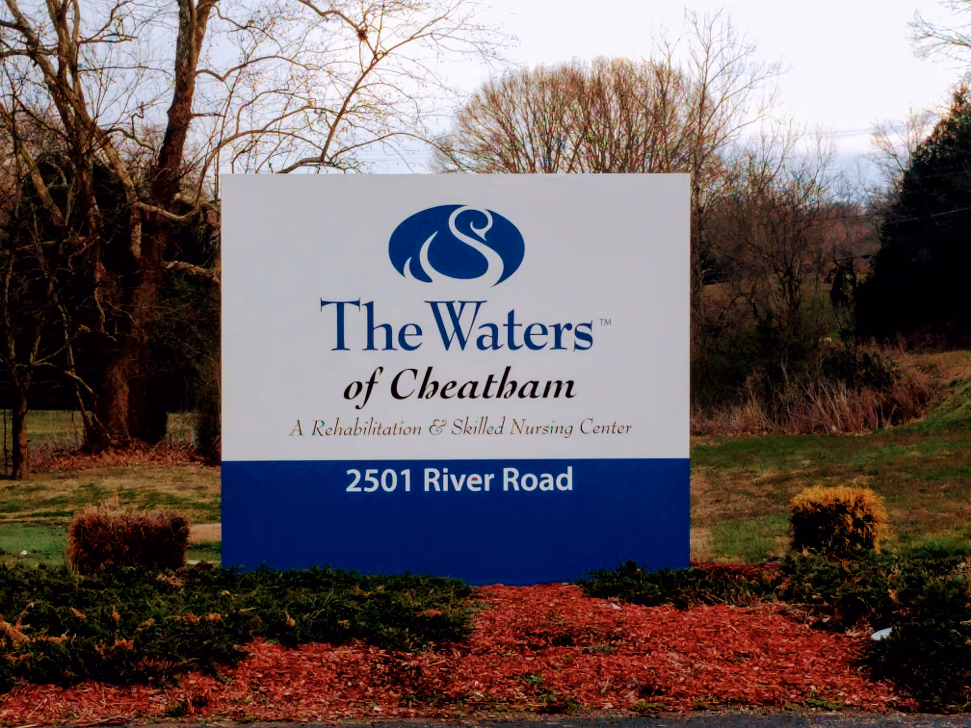 Large white and blue sign for The Waters of Cheatham on a grassy lawn.