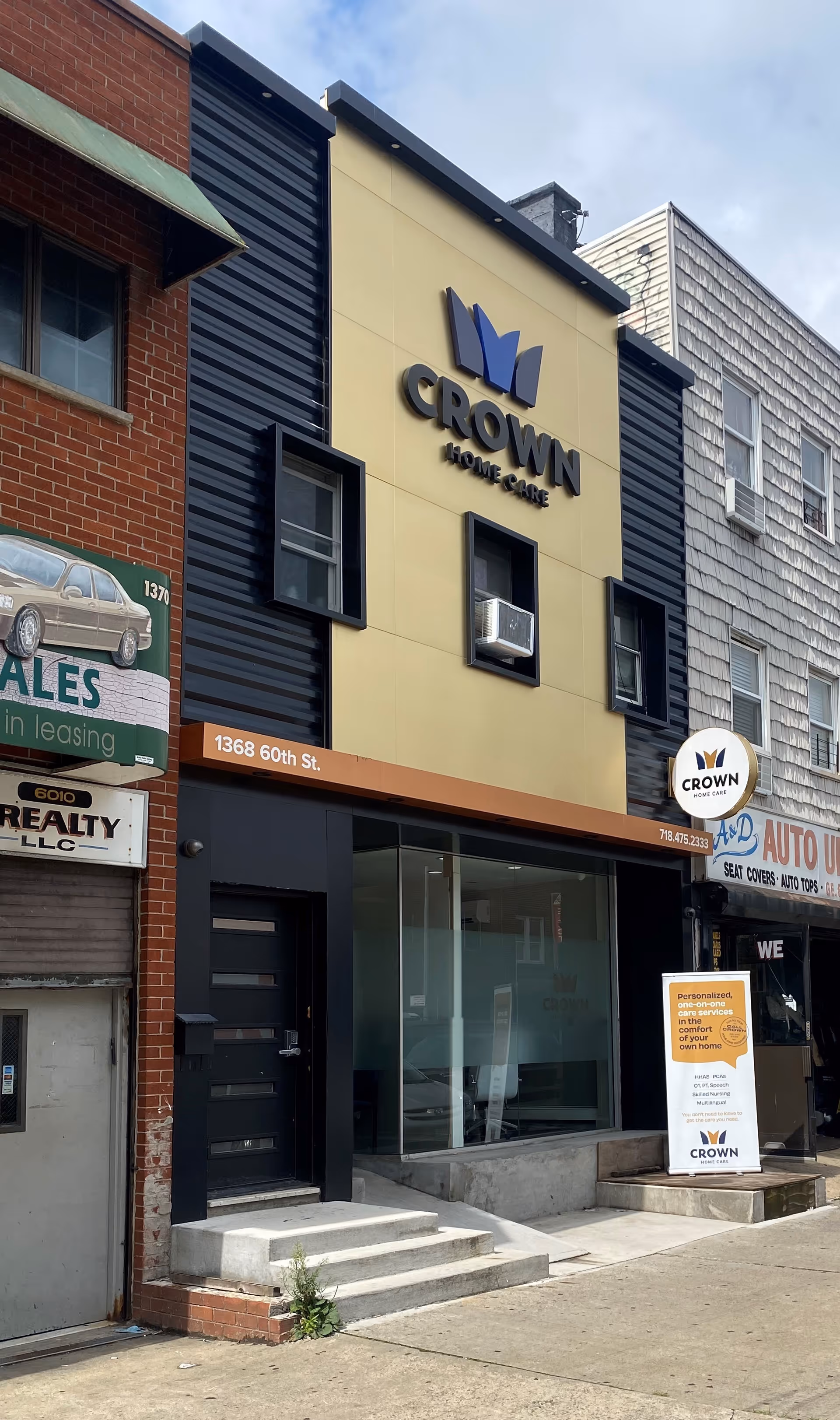 Storefront of Crown Home Care with yellow sign and logo on a modern facade.