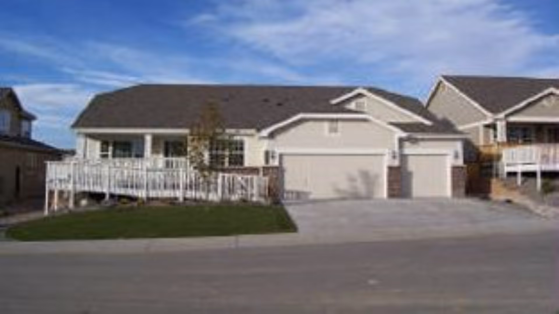 Front exterior view of Birchwoods at Canco Senior Living with a two-car garage and driveway.