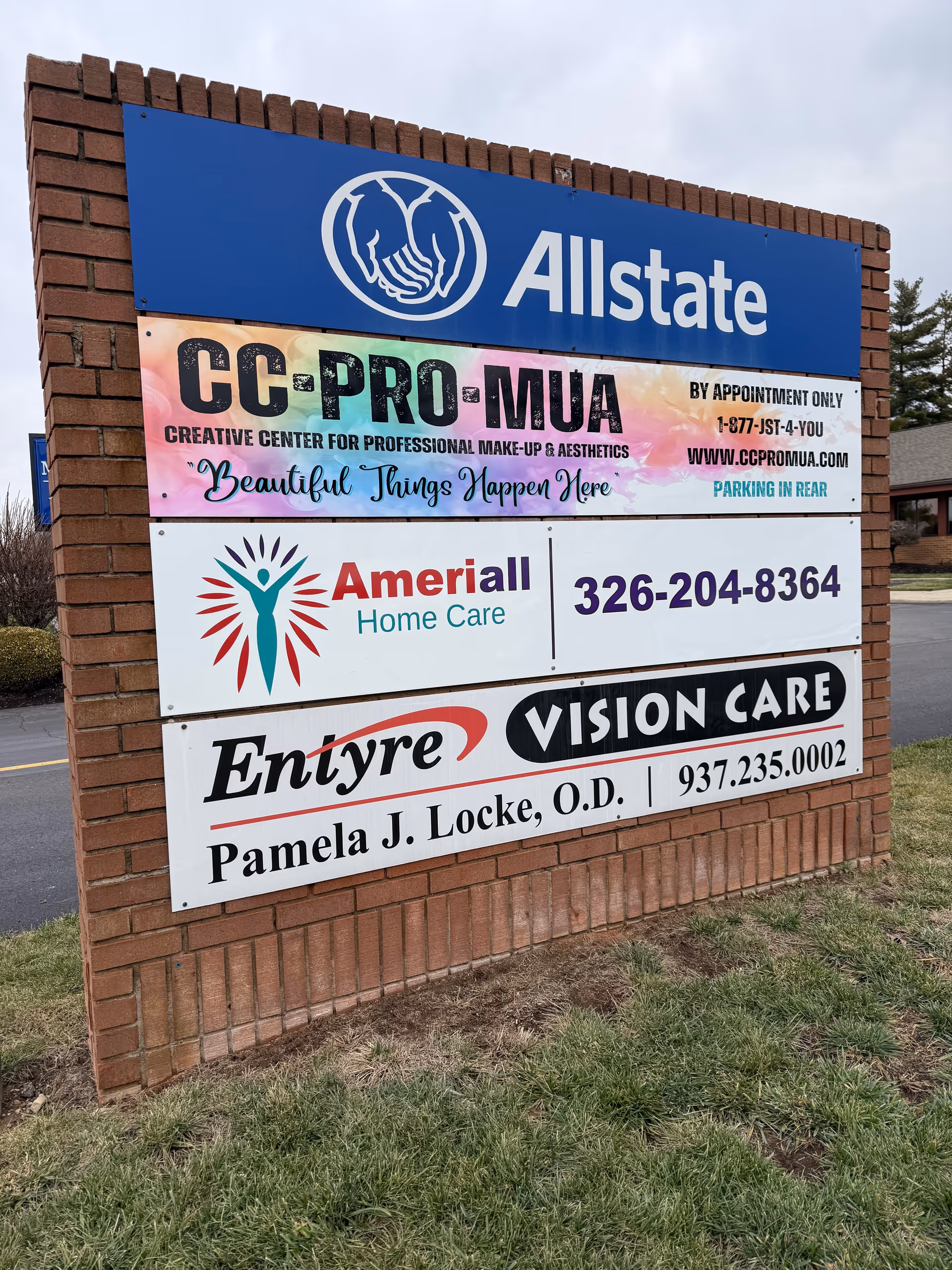 Brick exterior sign with Allstate logo and Ameriall Home Care among other business signs.