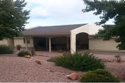Front view of Mountain View Manor, a single-story senior facility with a covered entrance.