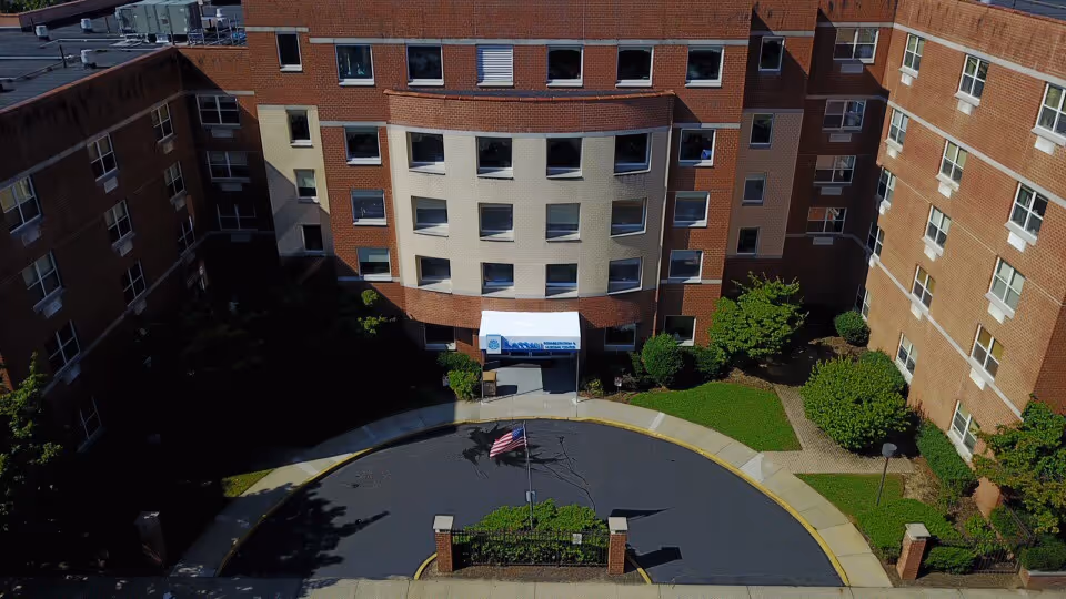Aerial view of Nassau Rehabilitation & Nursing Center entrance with curved driveway.