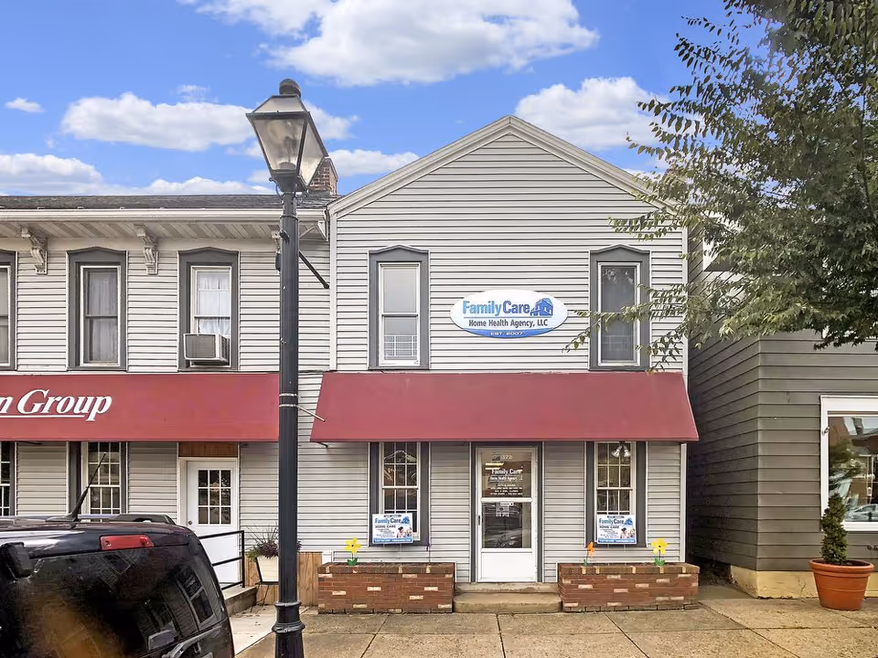 Two-story building with red awnings and Family Care Home Health Agency storefront.