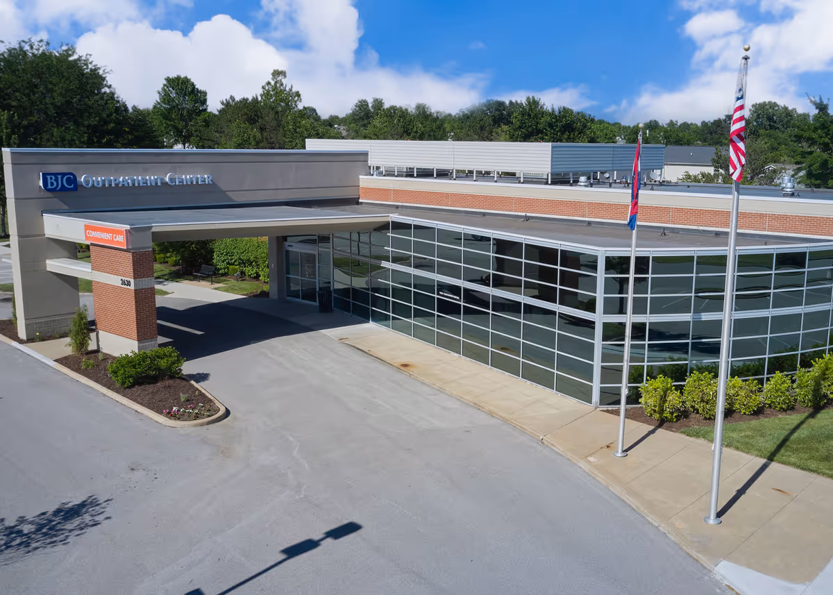 Aerial view of BJC Outpatient Center at O'Fallon, showing glass-front entrance and American flags.