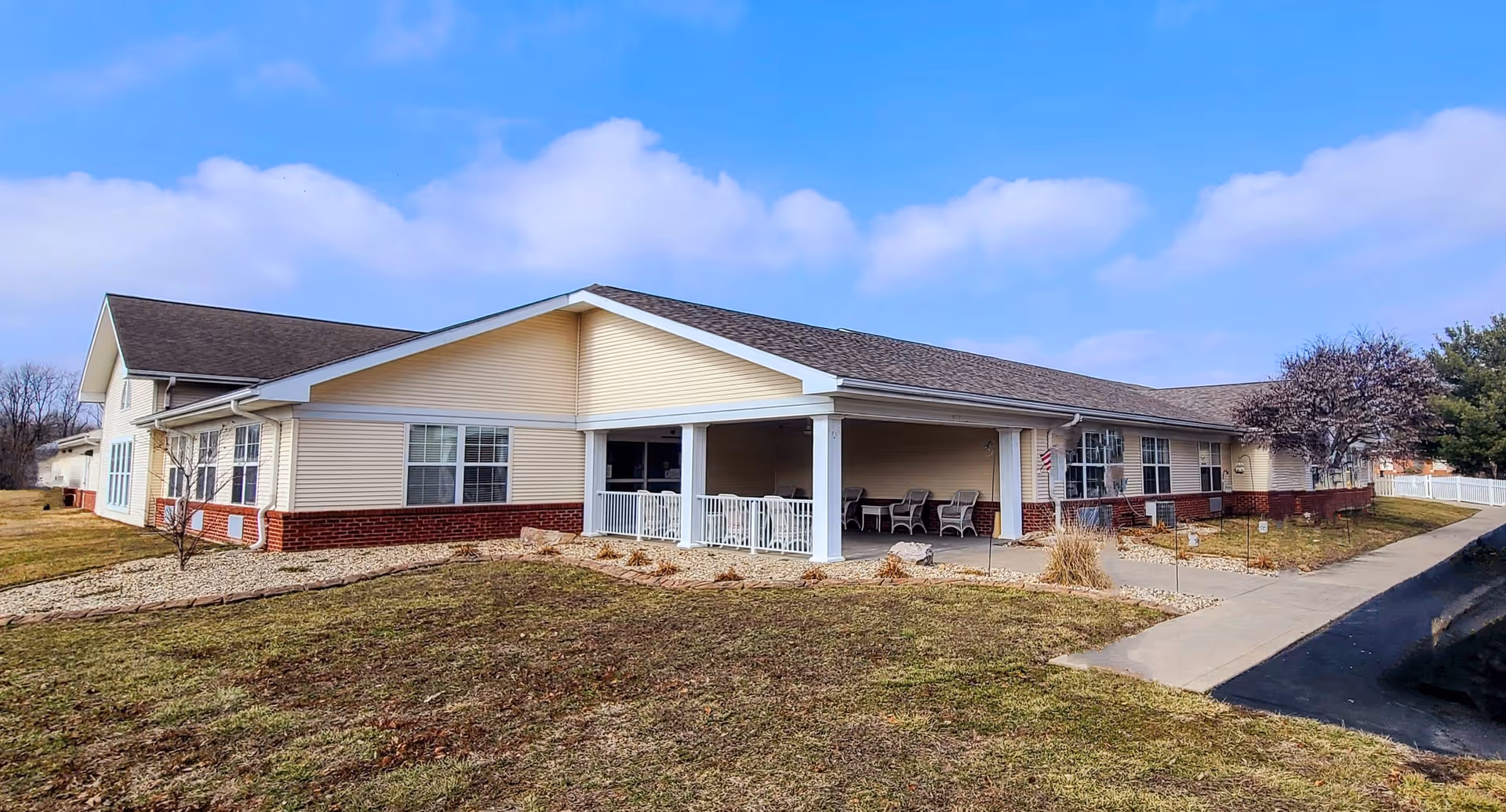 A single-story Oakview Villa building with a covered front porch and seating area.