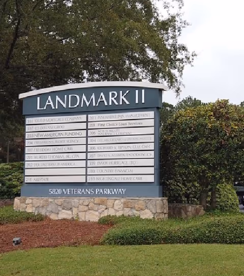 Outdoor sign reads Landmark II with directory boards and landscaping in front.