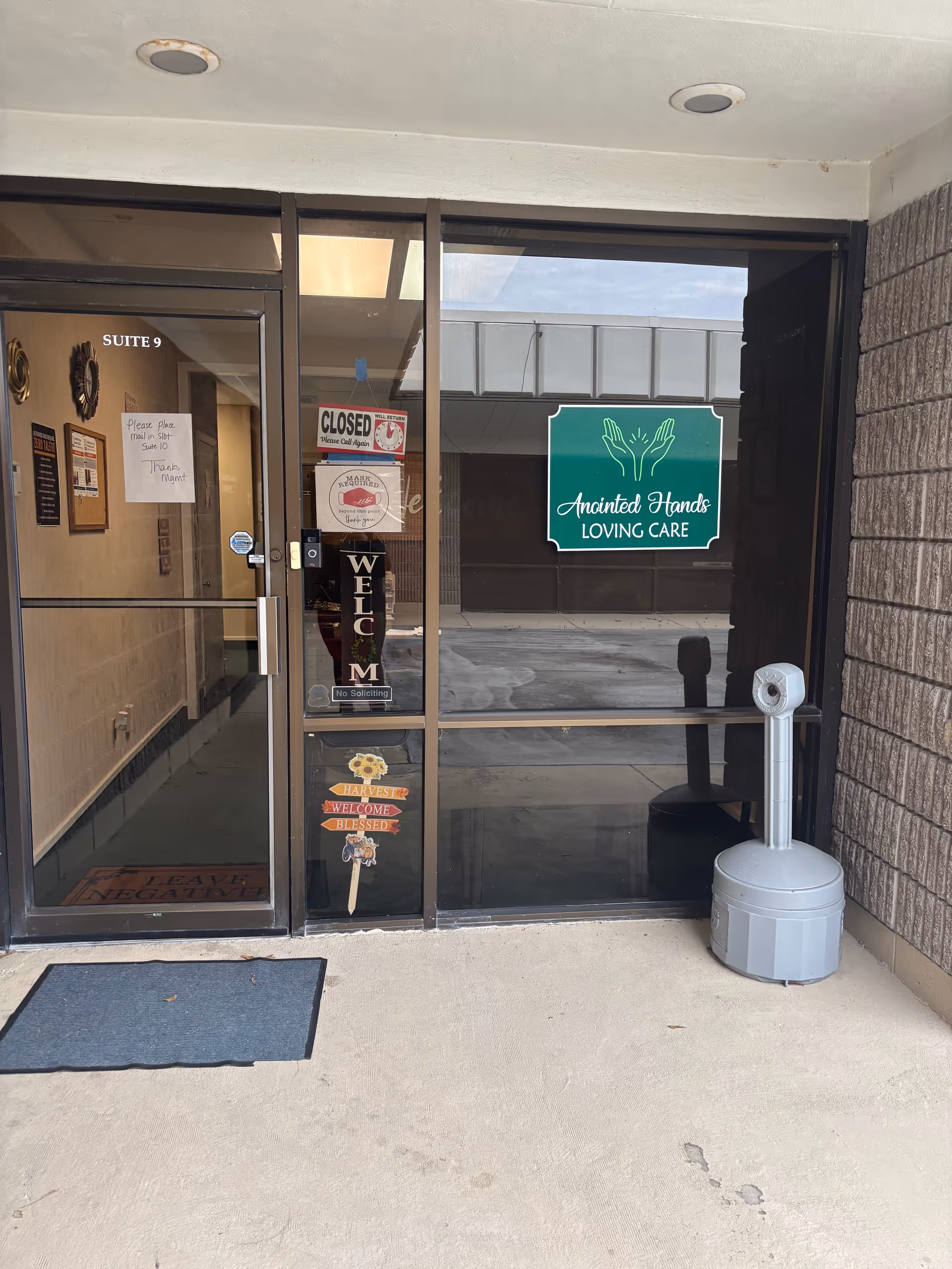 Entrance to Anointed Hands Loving Care facility with glass doors and signage
