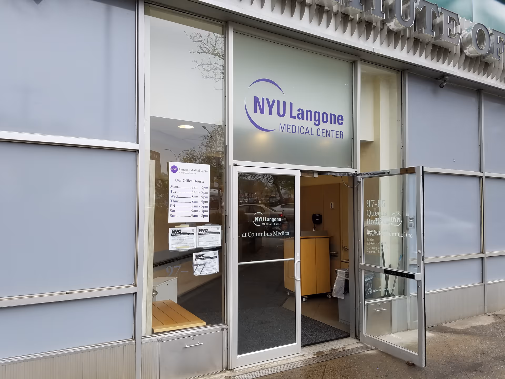 Exterior of NYU Langone Ambulatory Care Rego Park showing glass doors and signage.