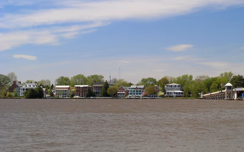 Riverside neighborhood with houses and trees along the water