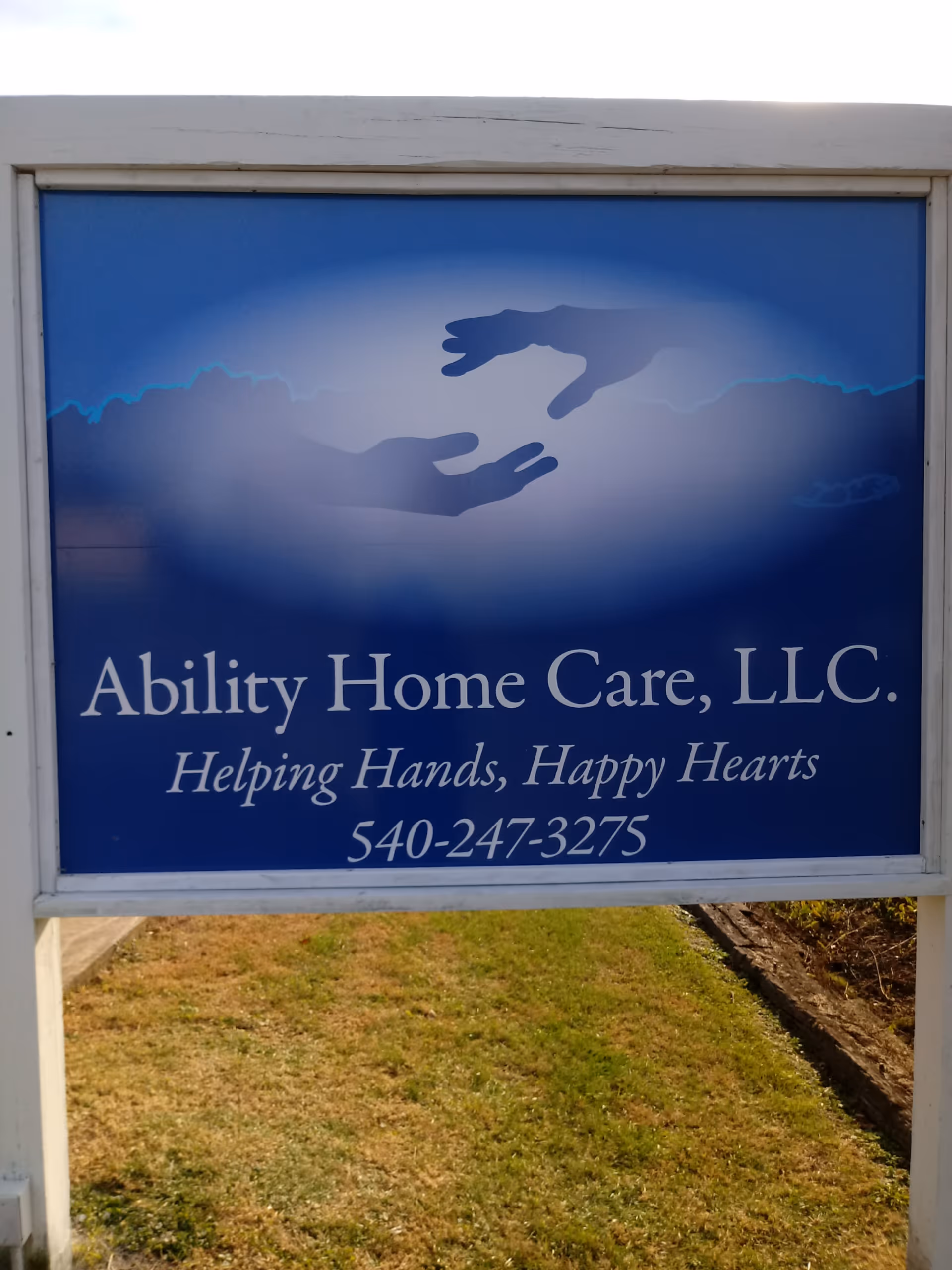 Blue outdoor sign for Ability Home Care, LLC with slogan and phone number