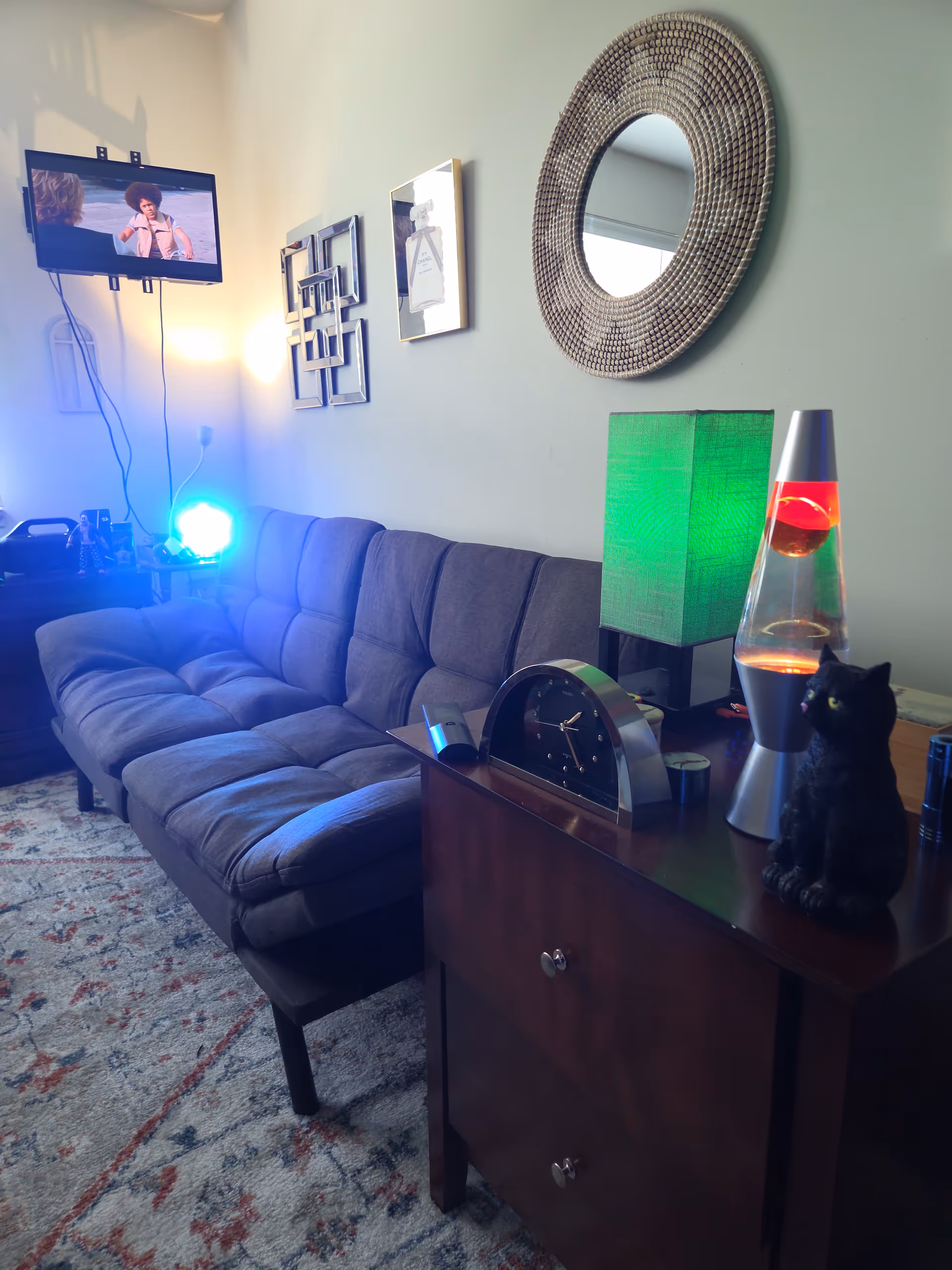 Stonebridge of Gurnee living room with sofa, wall art, lamps, and a TV.