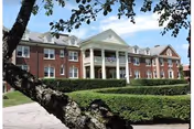 Exterior view of Golden Rockies Assisted Living building with brick facade and columned entrance.
