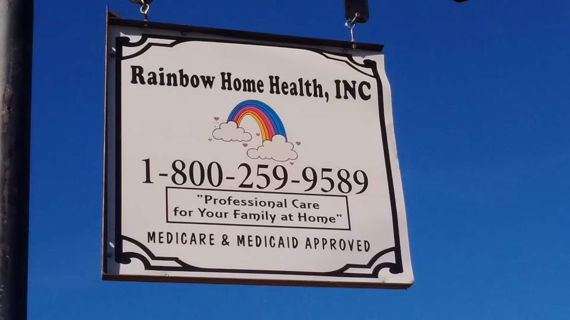 Outdoor sign for Rainbow Home Health, INC with phone number and rainbow illustration