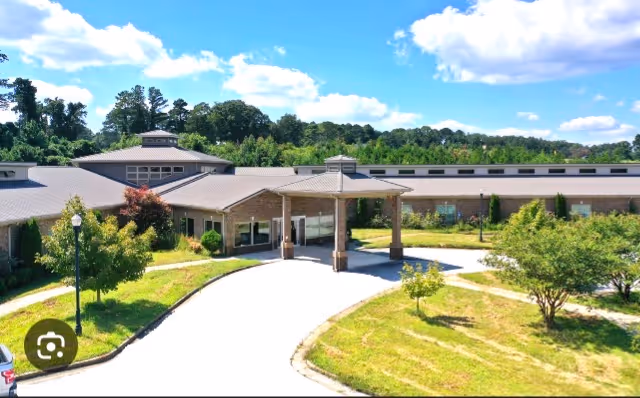 Exterior view of Elderville Assisted Living facility with entrance canopy and curved driveway