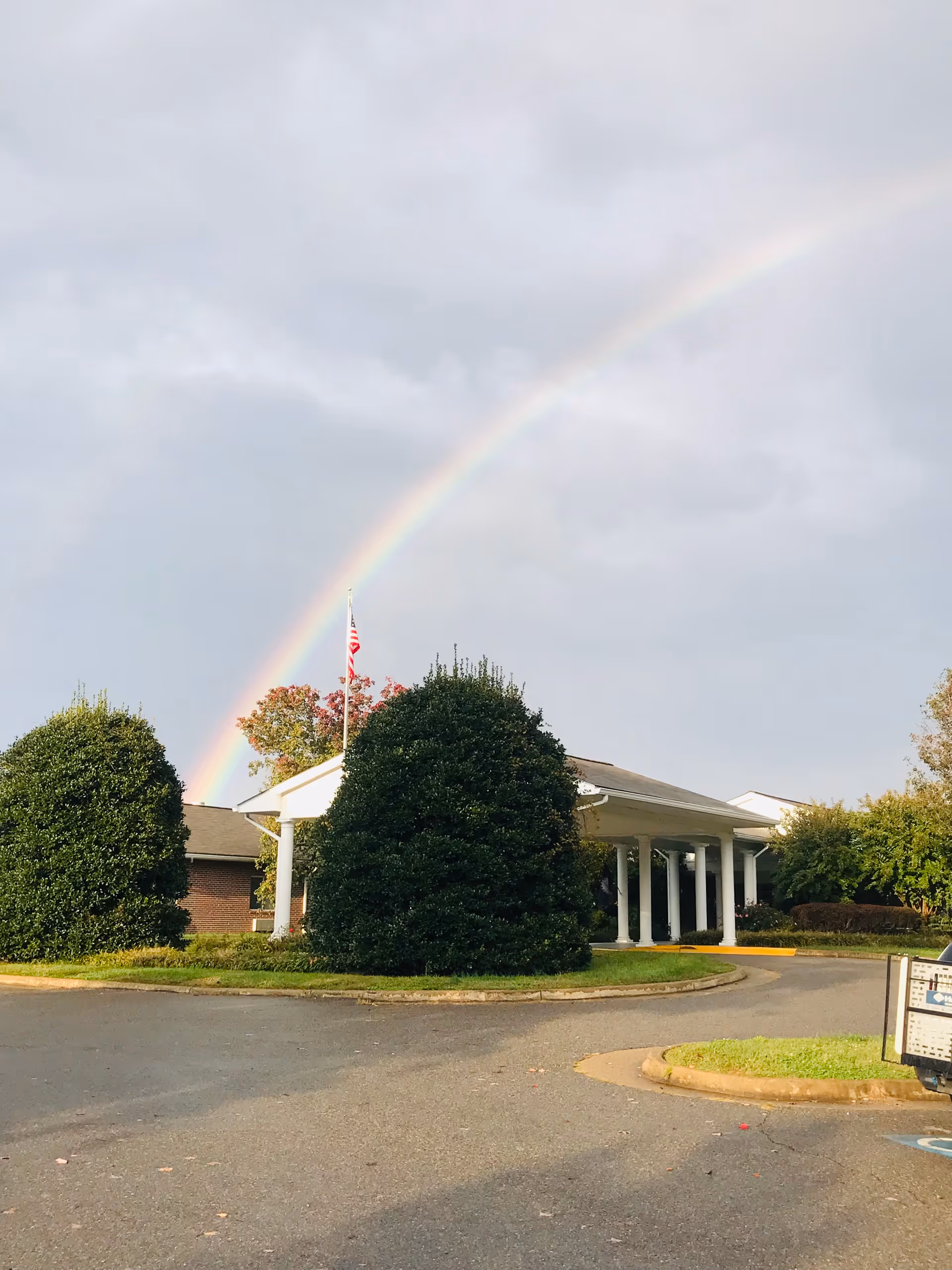 Front of Meadows Nursing Center with a rainbow arcing over the entrance.