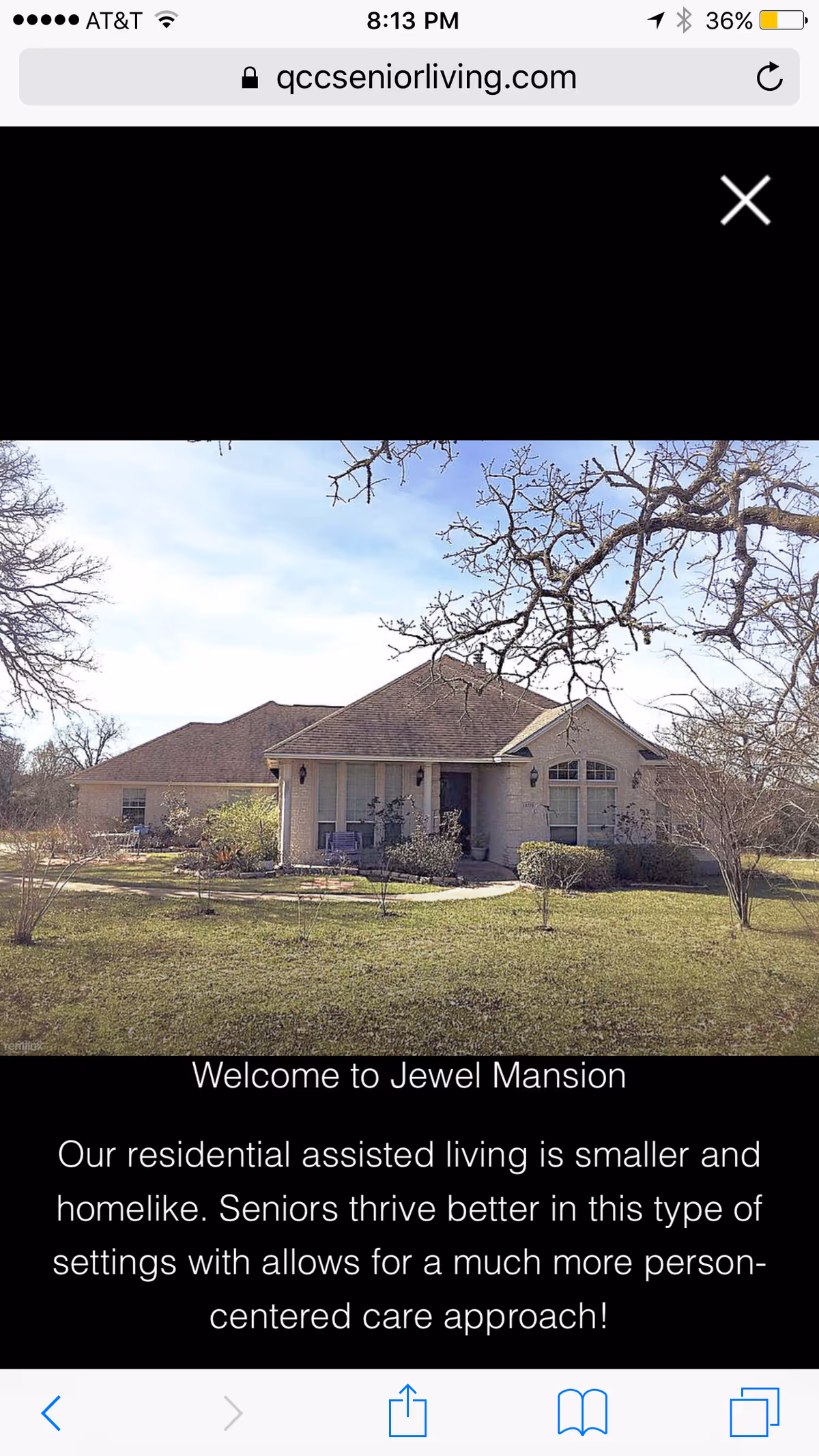 Front view of Jewel Mansion senior living facility with a manicured lawn and trees.