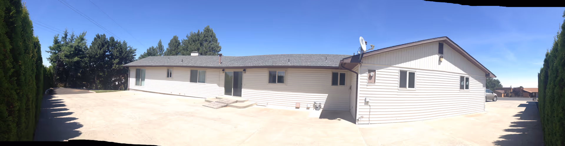 Robville LLC Adult Family Home exterior with wide driveway and hedges.