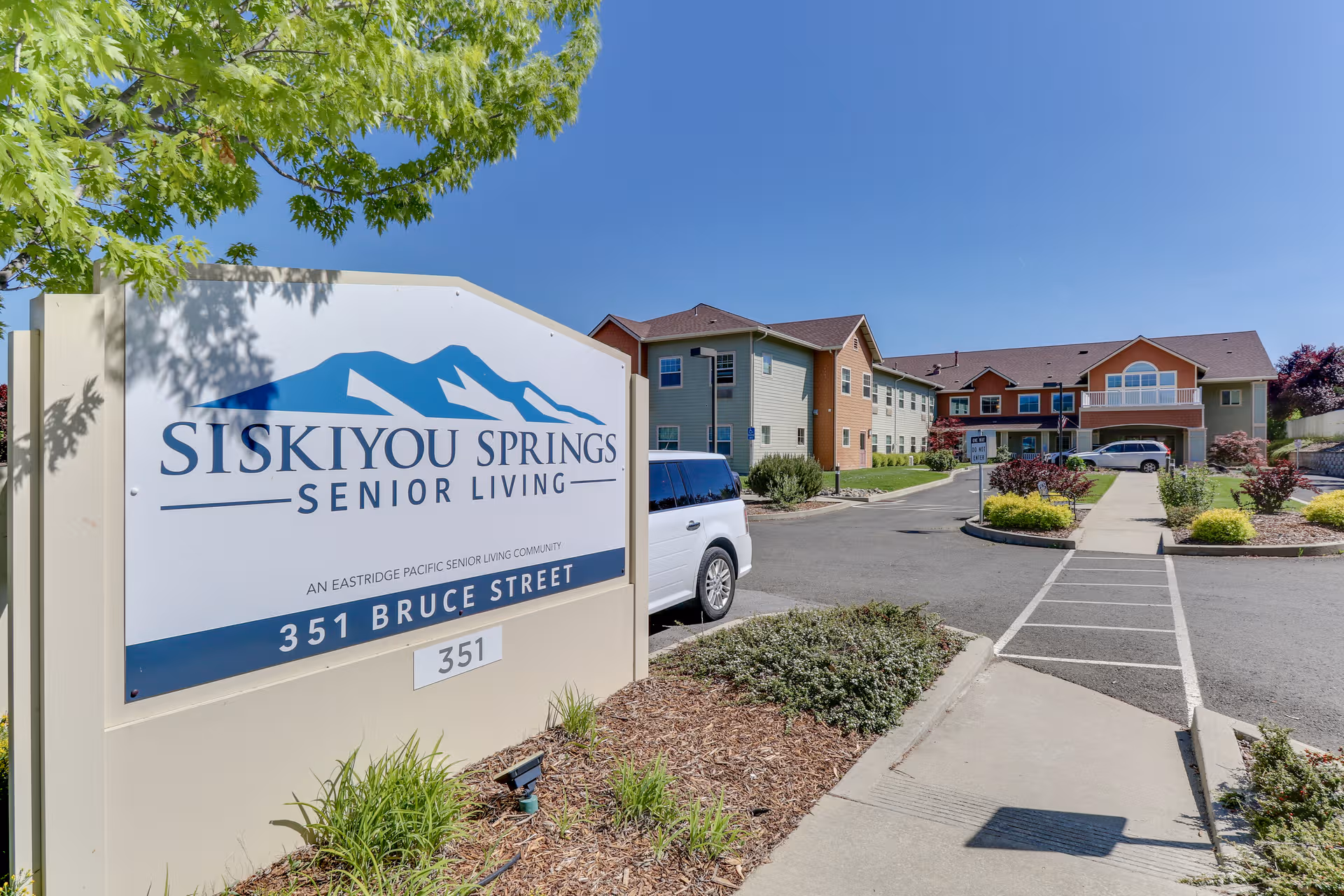 Siskiyou Springs Senior Living sign with the facility's exterior and parking.